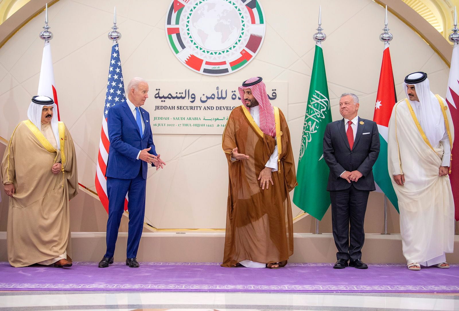 President Biden and Saudi Crown Prince Mohammed bin Salman appear to exchange words during the photos