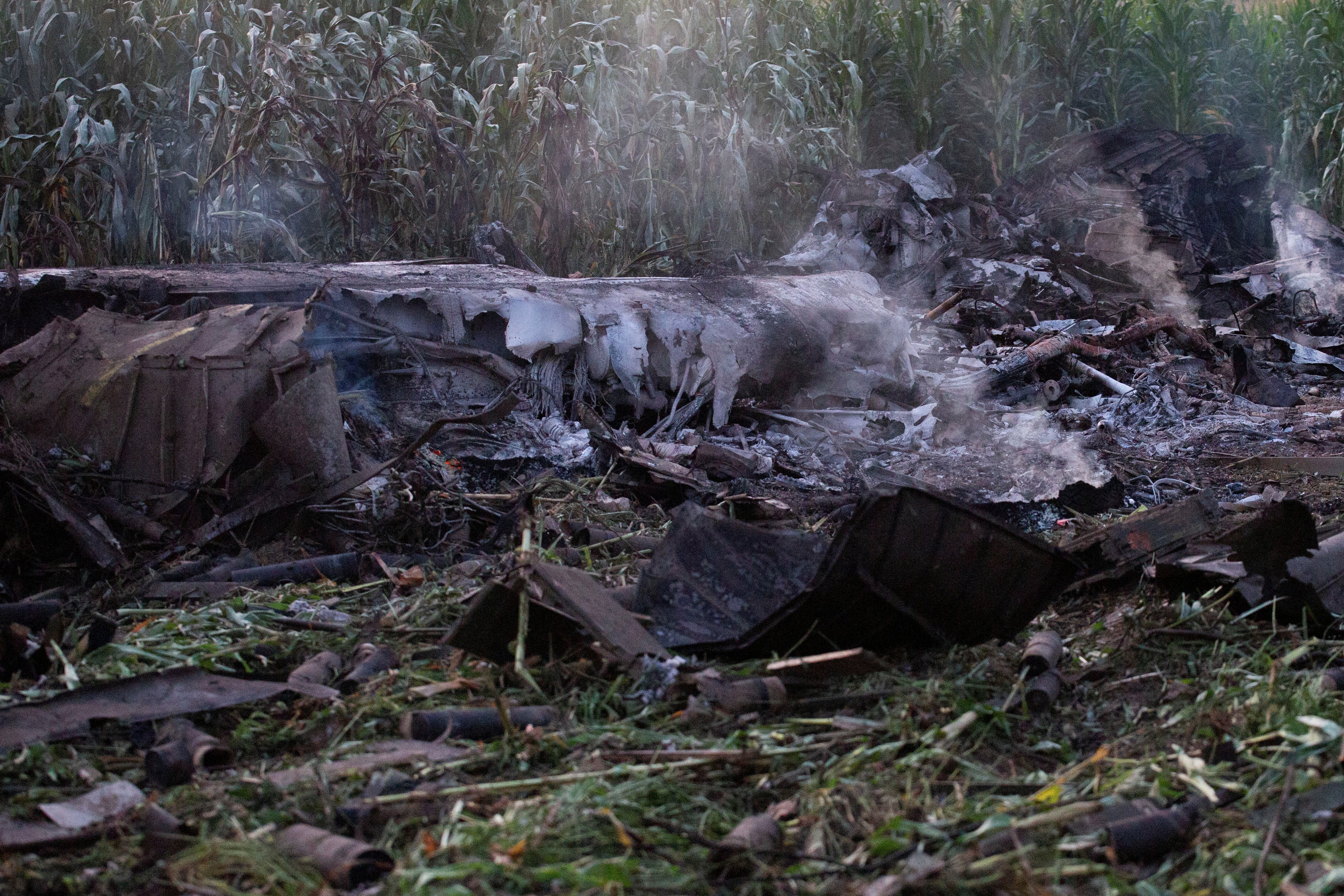 Debris is seen at the crash site of an Antonov An-12 cargo plane