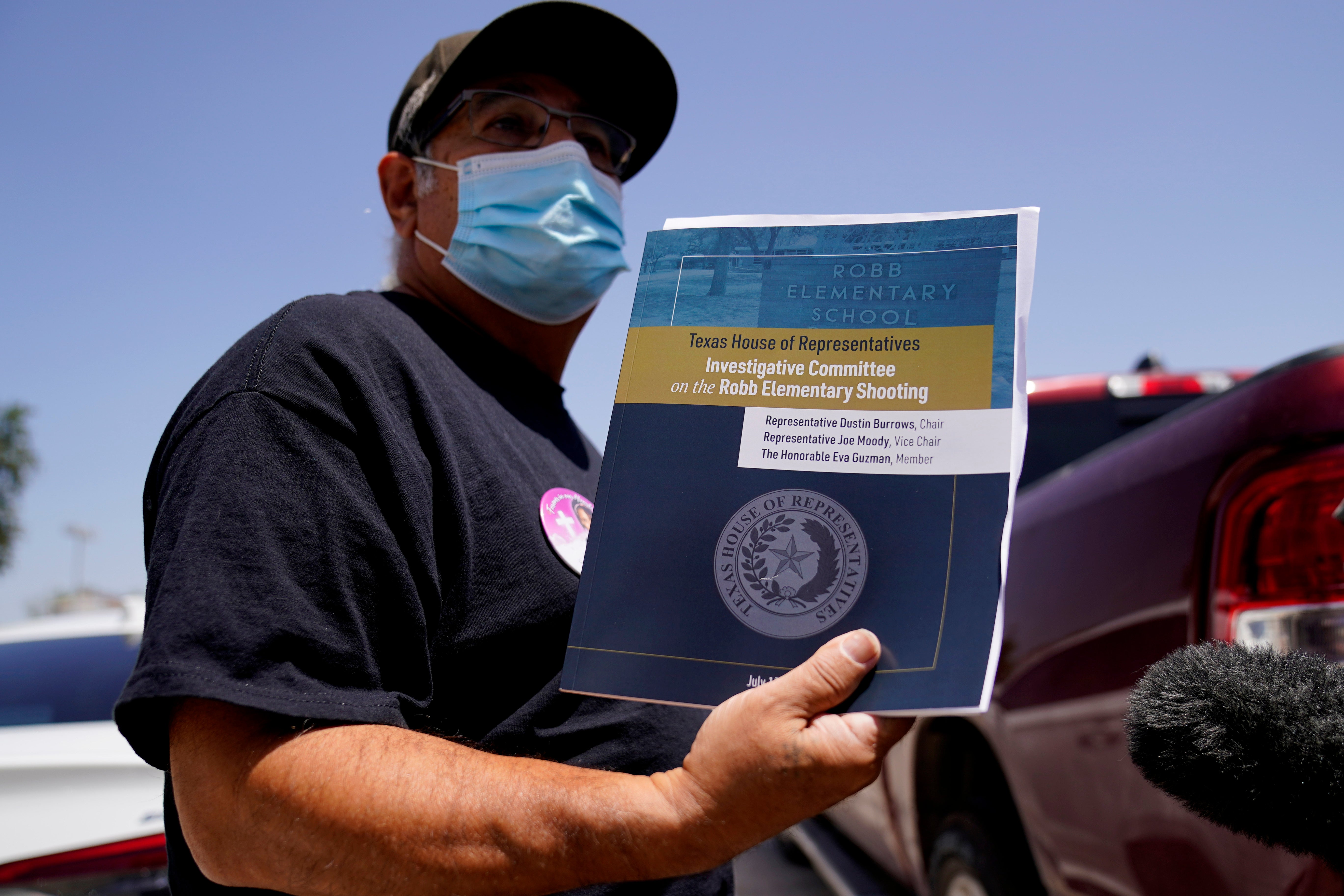 Vincent Salazar, grandfather of Layla Salazar who was killed in the school shooting at Robb Elementary, holds the Texas House committee report