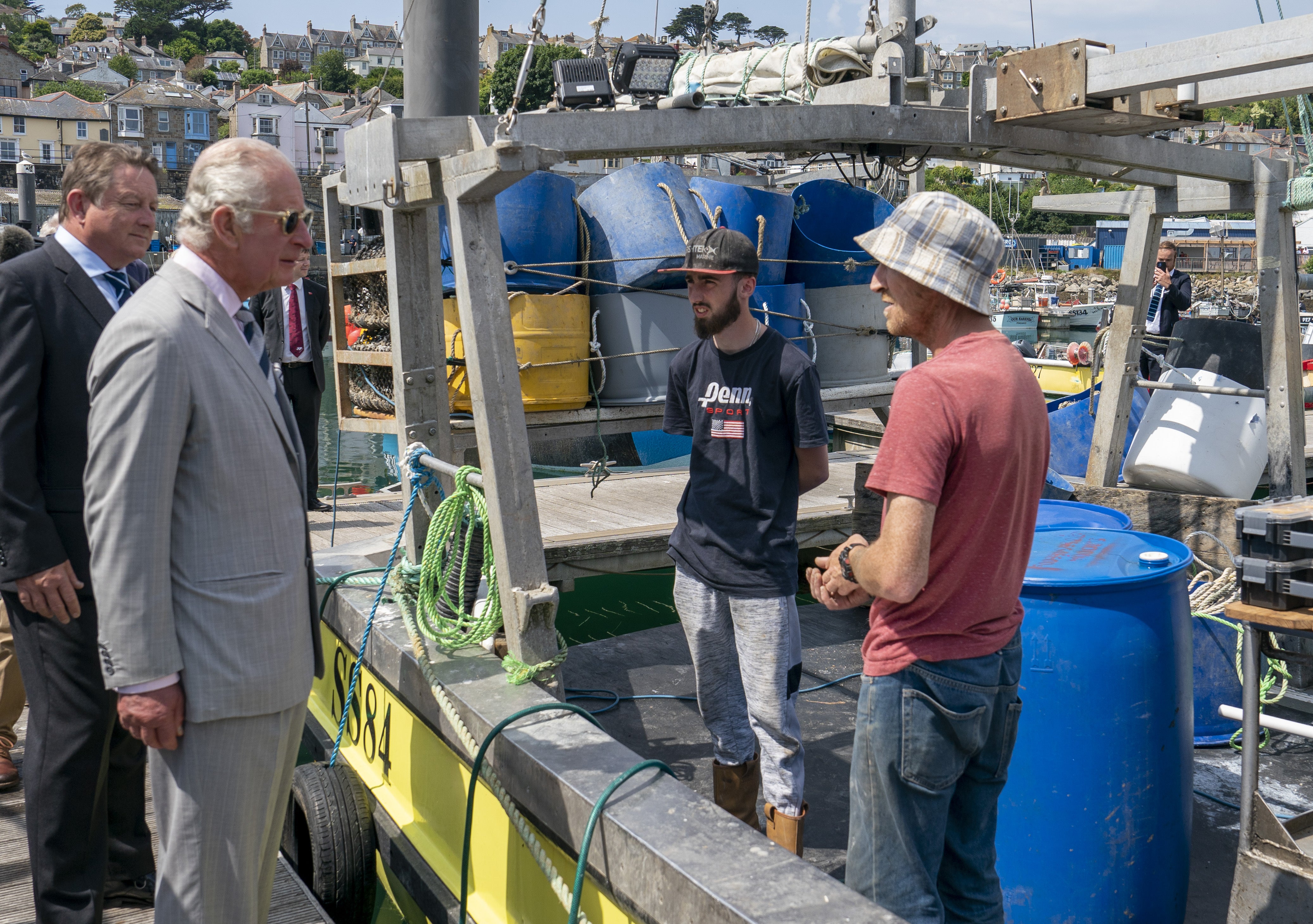 The Prince of Wales talks to local fishermen (Arthur Edwards/The Sun/PA)