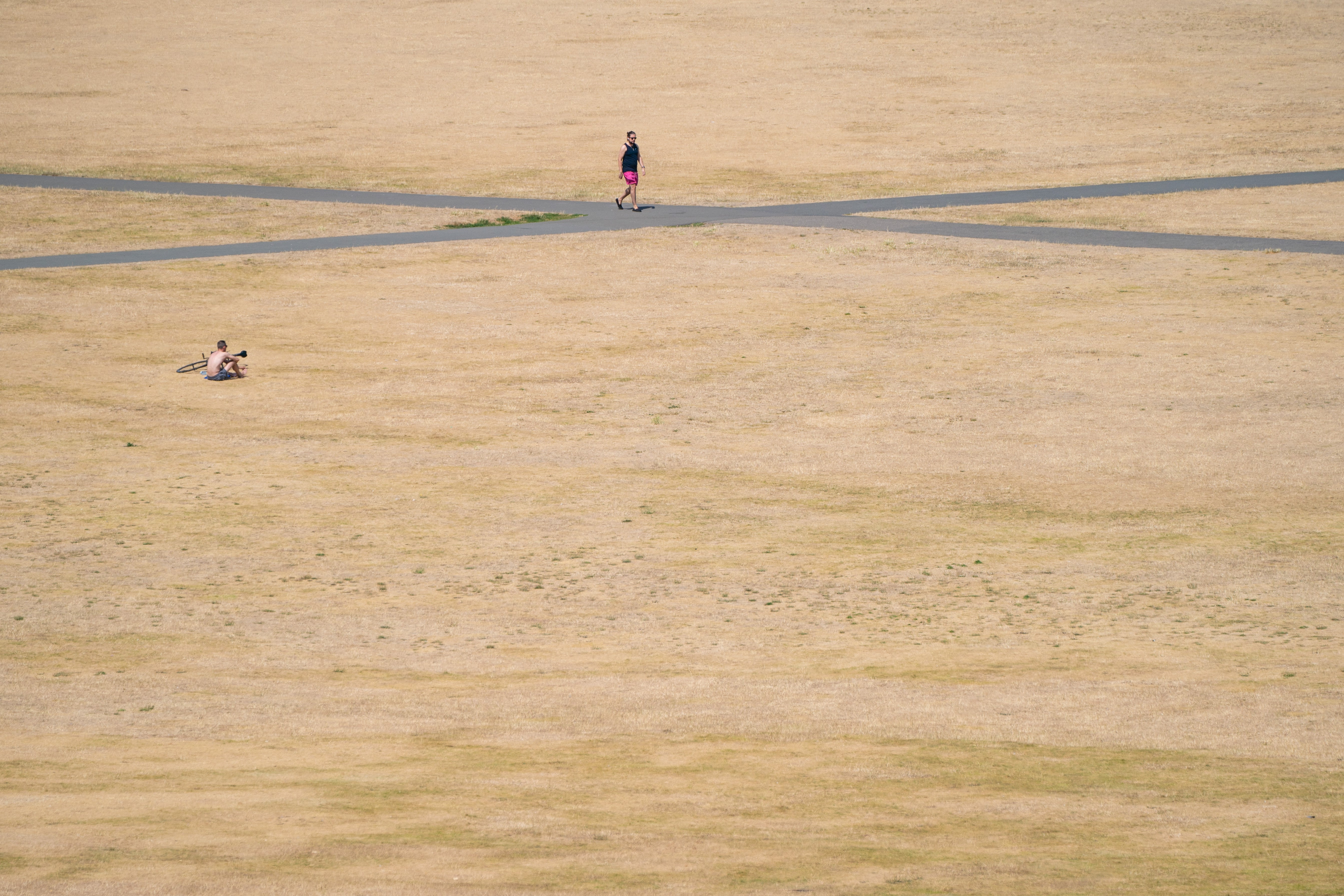 People walk in the sun in Greenwich Park, south-east London (Dominic Lipinski/PA)