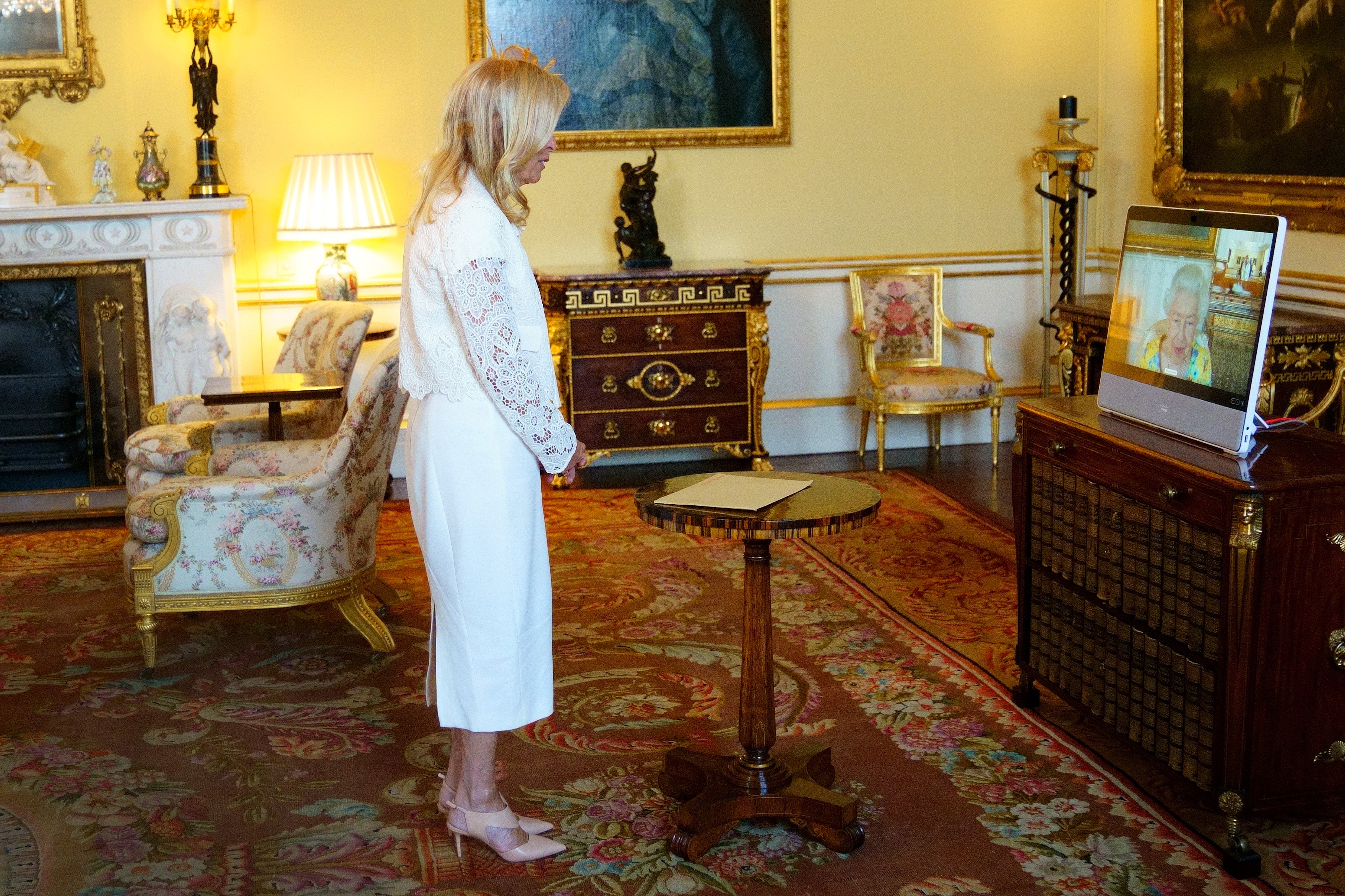 The Queen, in residence at Windsor Castle, appears on a screen via videolink, during a virtual audience to receive the US ambassador, Jane Hartley (Victoria Jones/PA)