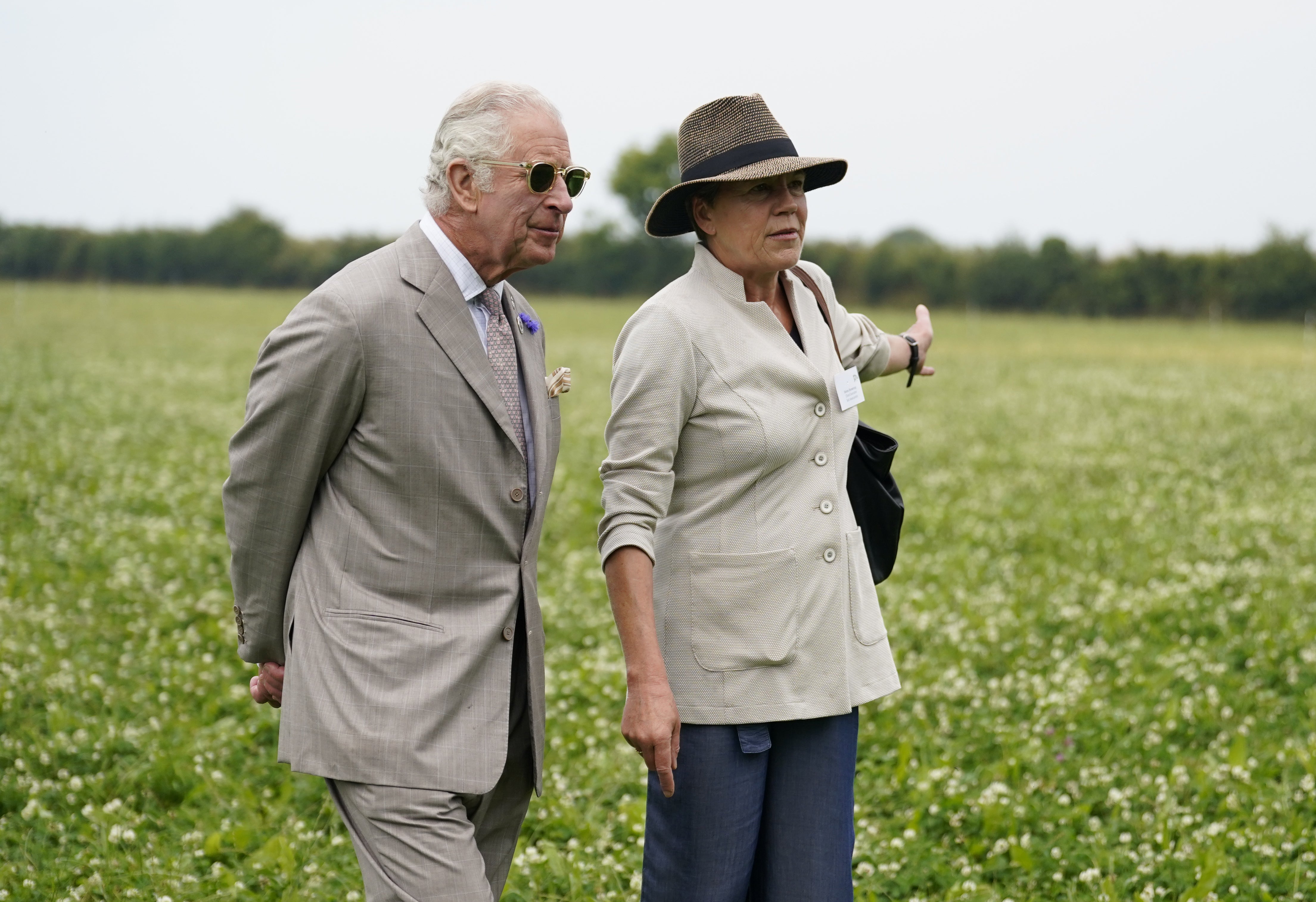 Charles chats with Helen Browning, Group CEO Soil Association, as they walk through herbal leys as he attends the Innovative Farmers 10th anniversary at Trefranck Farm (Andrew Matthews/PA)