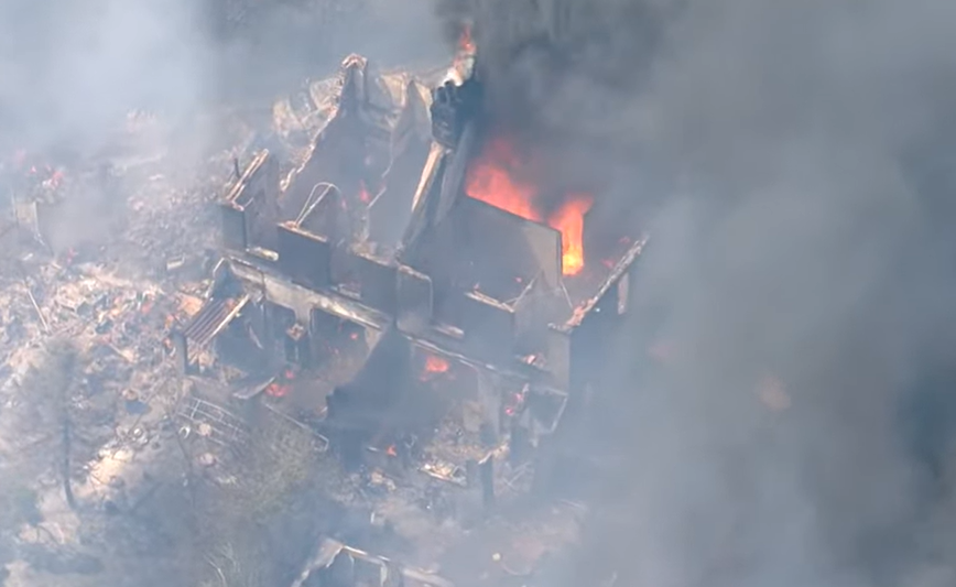 Around three hectares of a cornfield and some scrubland is alight and smoke is blowing over the M25