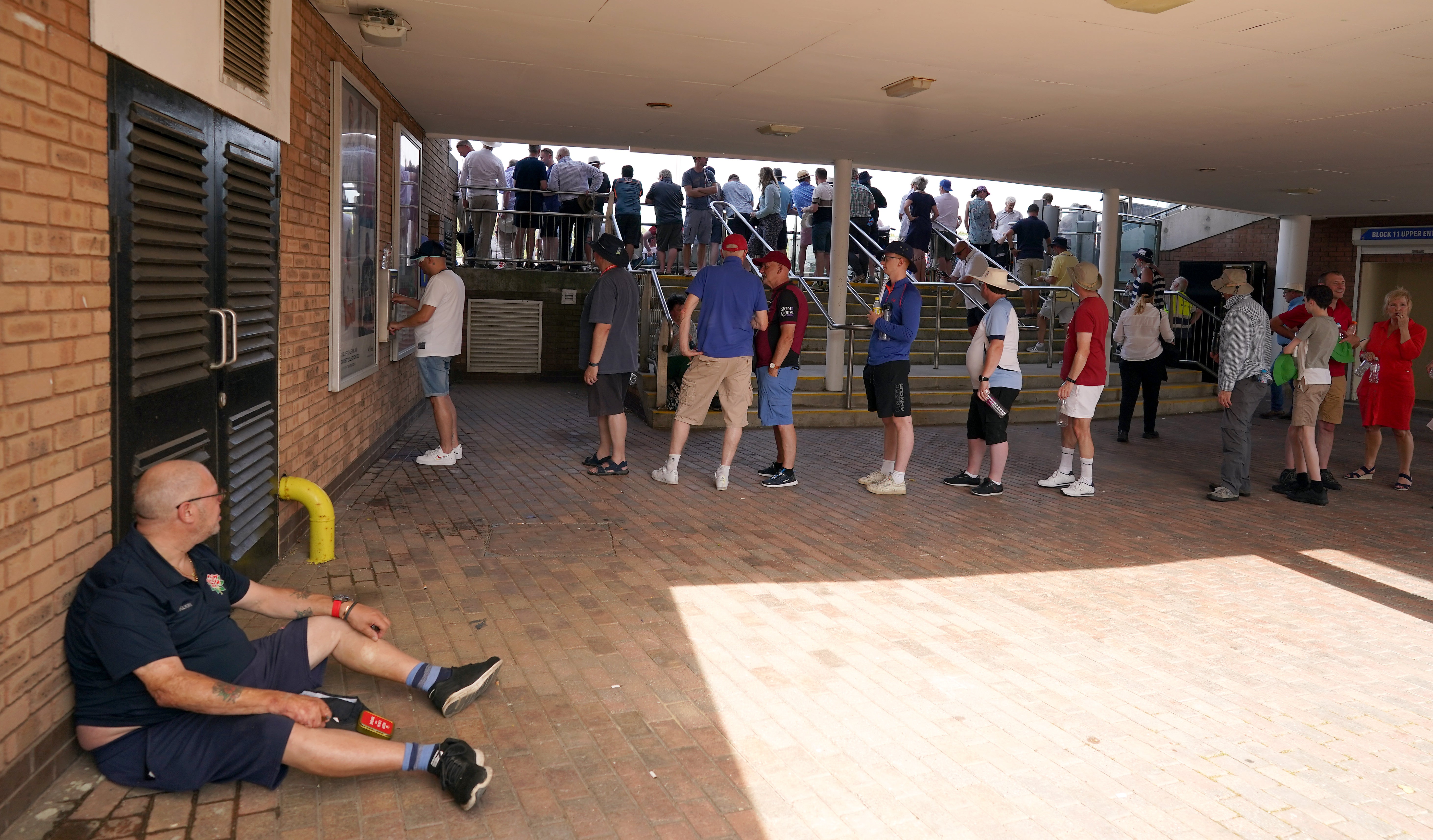 Fans queue for a water bottle filling station under the stands at Chester-le-Street (Owen Humphreys/PA)