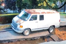 Video shows van being swallowed by a sinkhole after severe storms in NYC