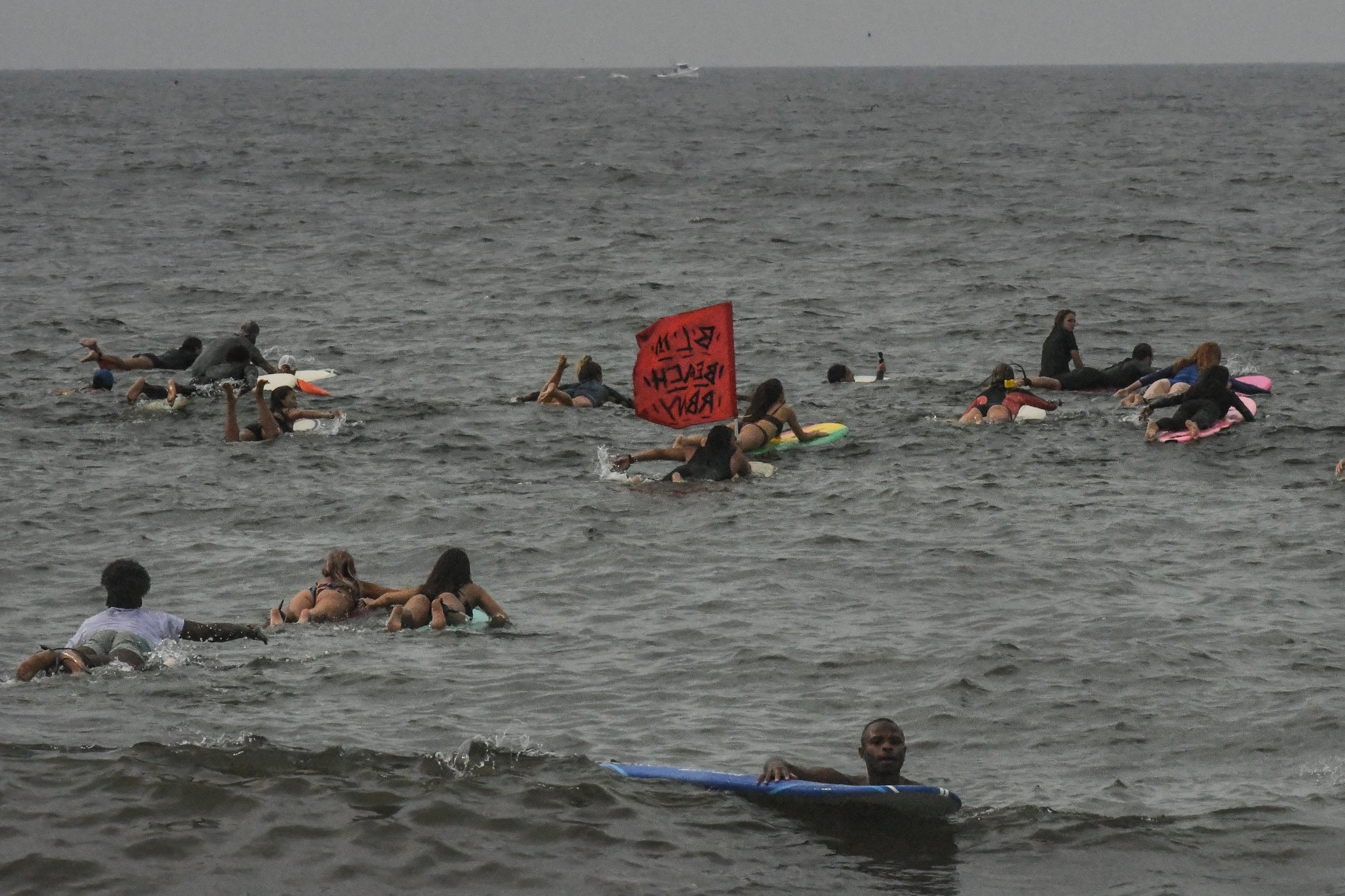 Surfers in the water off Rockaway Beach in the Queens borough of New York City in August 2021