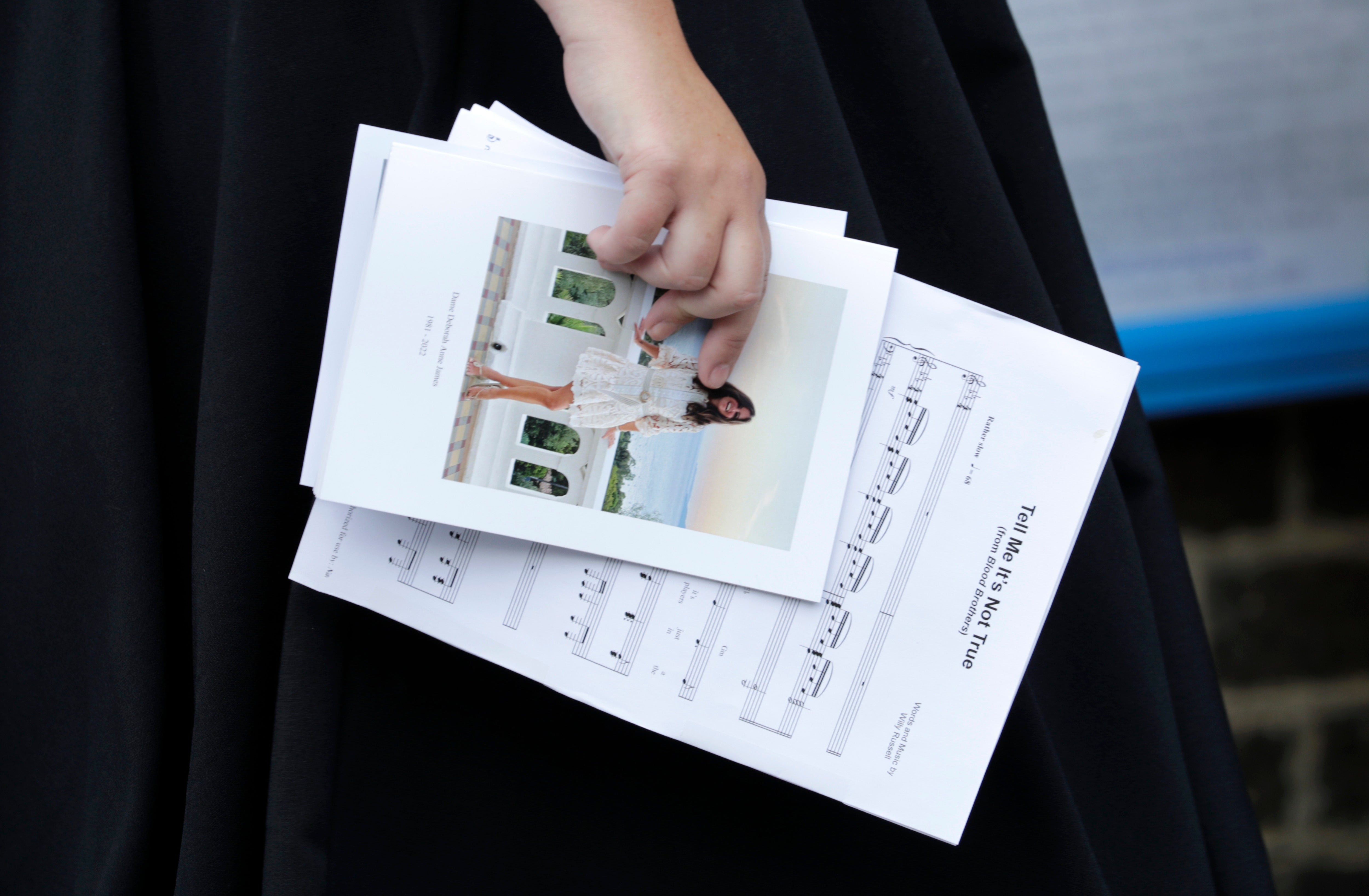 Sheet music and an order of service held by Natalie Rushdie as she attends the funeral of Dame Deborah James at St Mary's Church