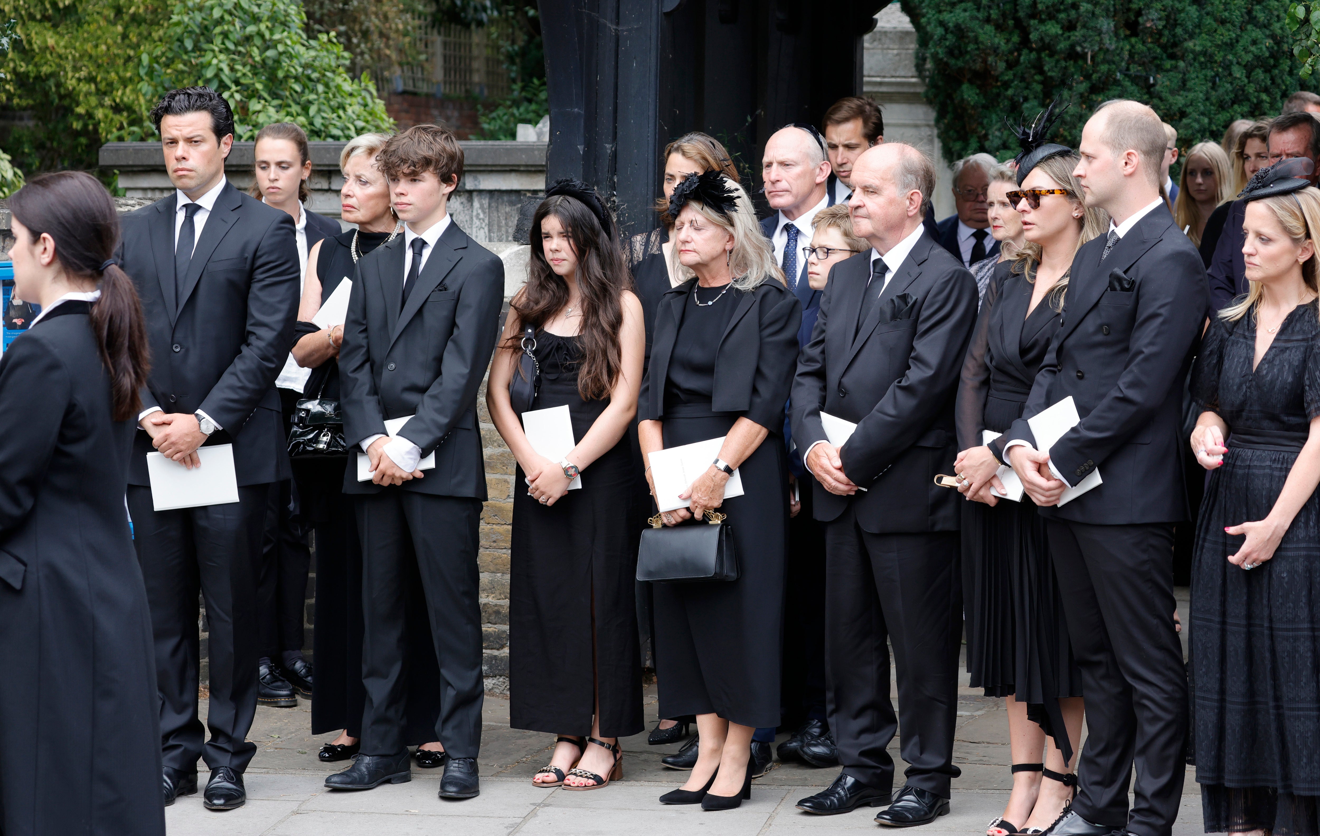 (L-R) Husband Sebastien Bowen, son Hugo Bowen, daughter Eloise Bowen, parents Heather James and Alistair James, guest, brother Ben James and sister Sarah James during the funeral of Dame Deborah James at St Mary’s Church