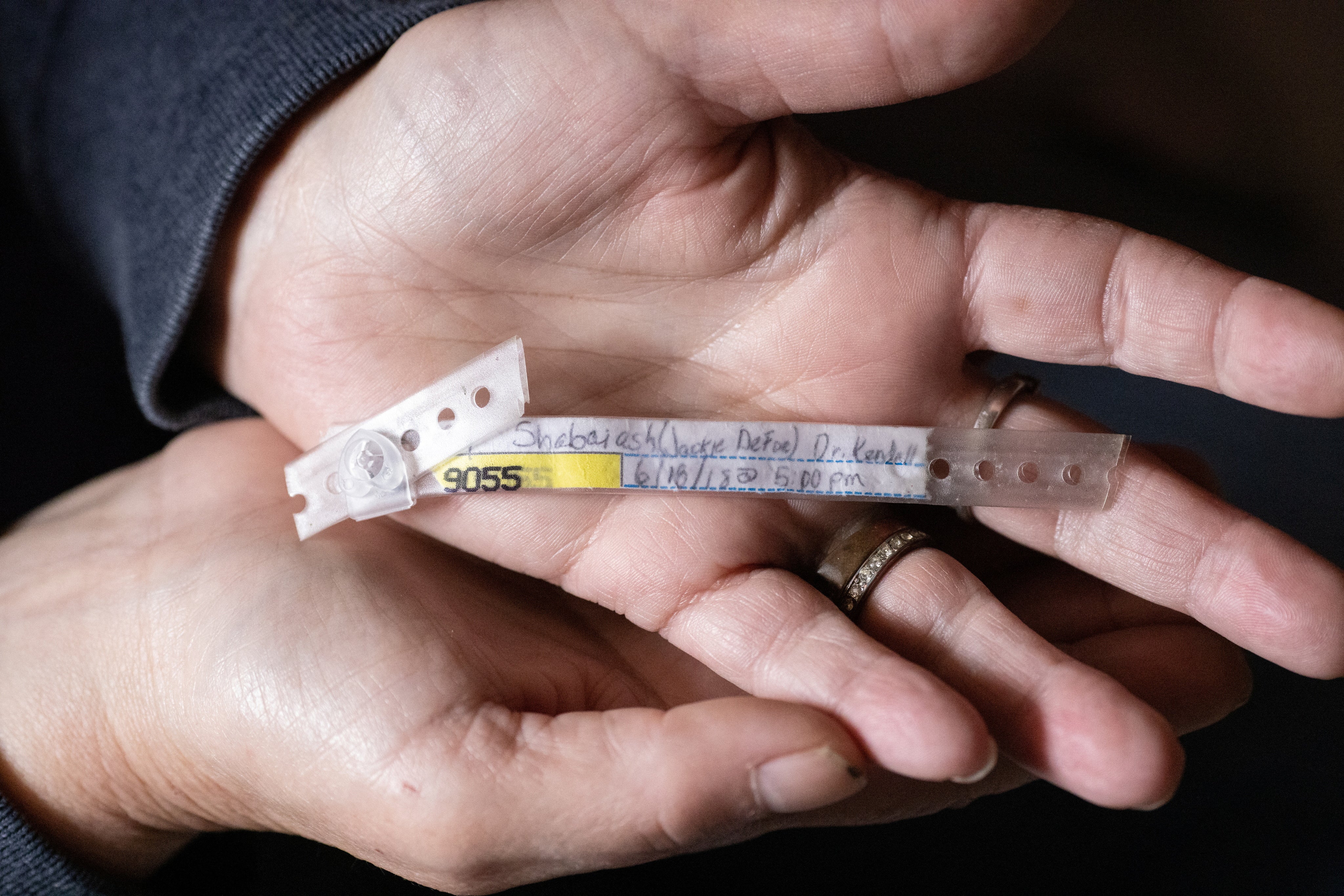 Suomi holds her grandson Kevin Shabaiash Jr’s hospital bracelet at her home