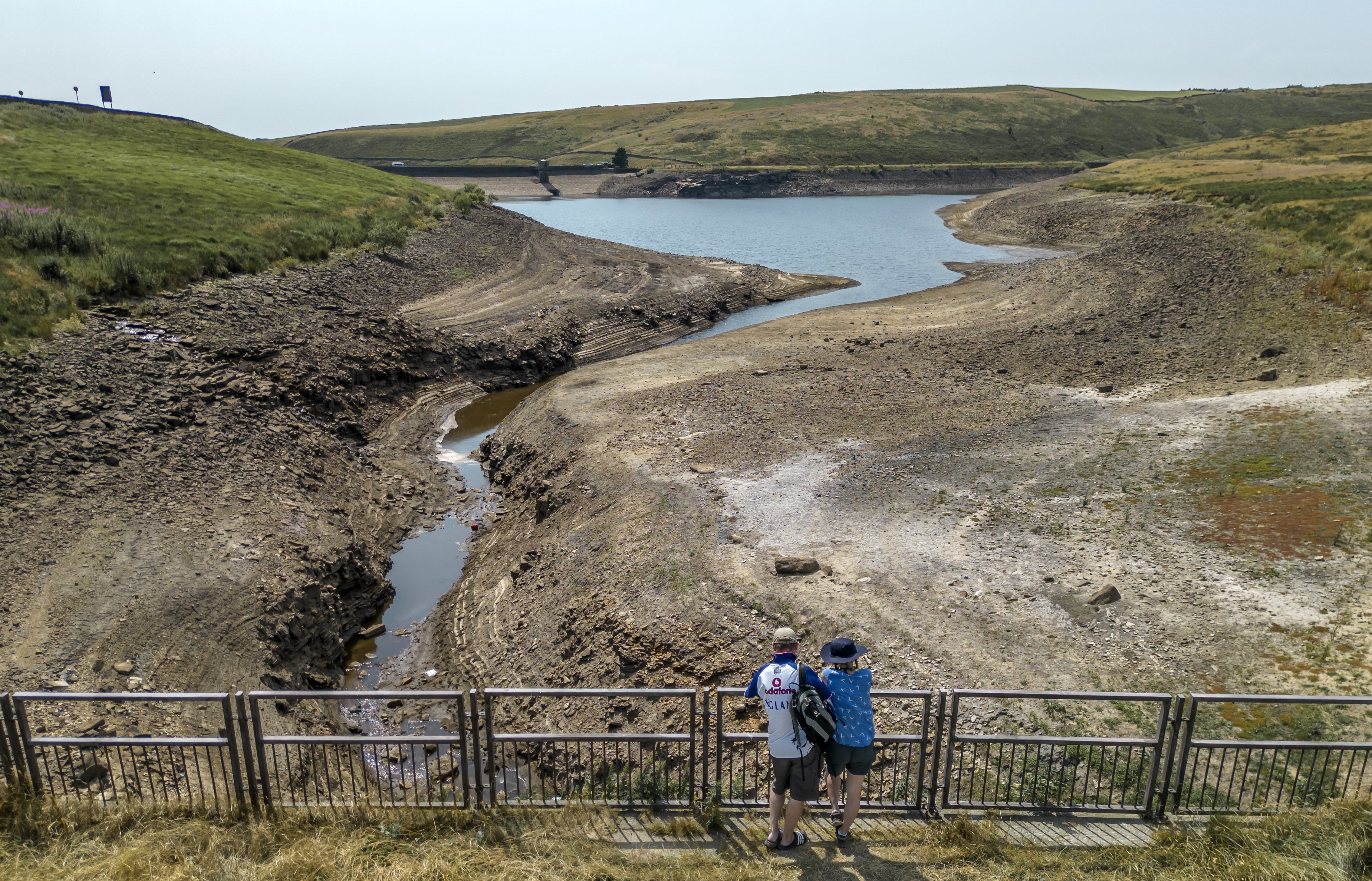 People look at a dry bank of a tributary to the Dowry Reservoir close to Oldham (Danny Lawson/PA)