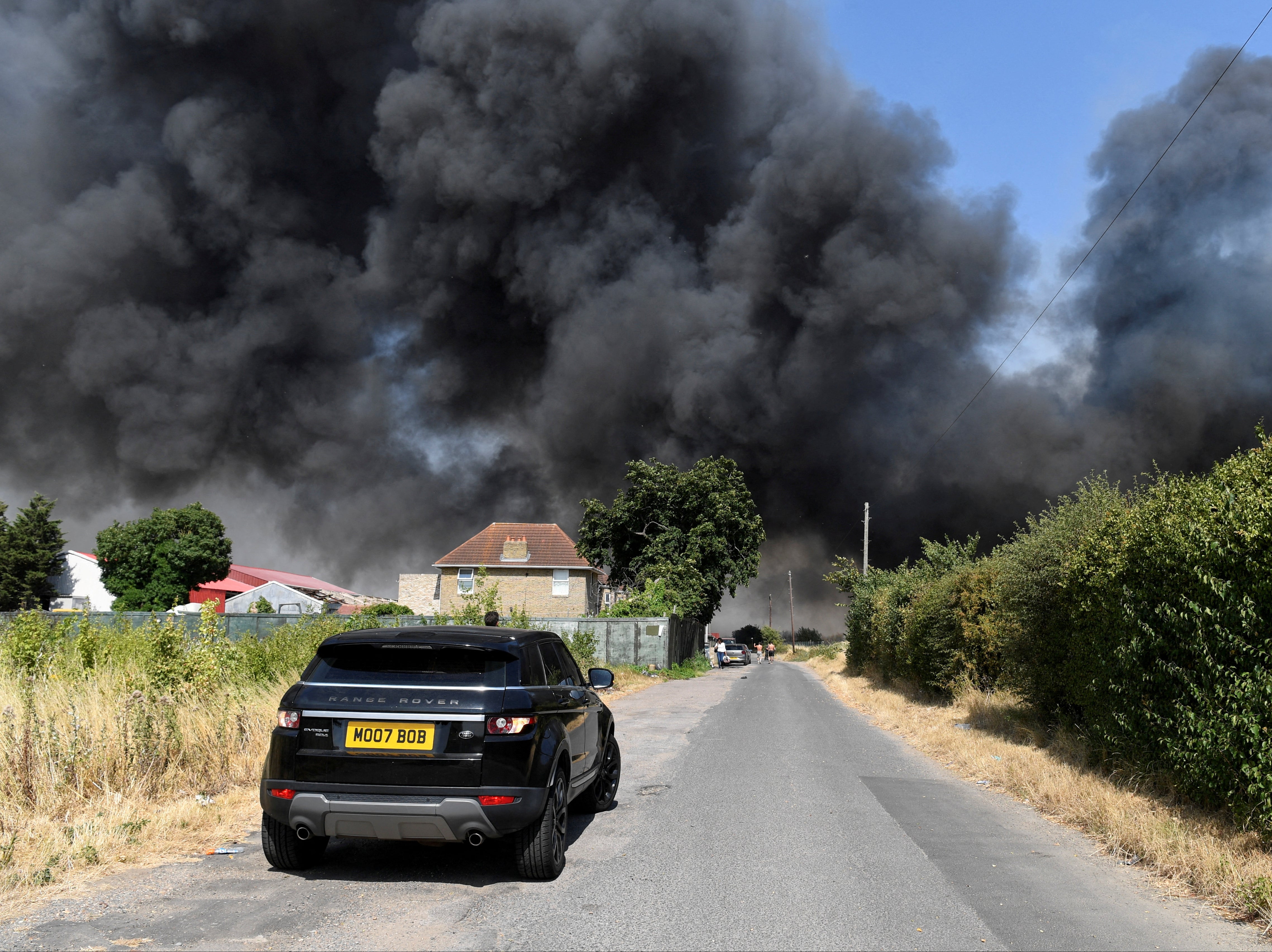 Dramatic aerial footage from the area captured thick plumes of black smoke billowing from a row of collapsing houses