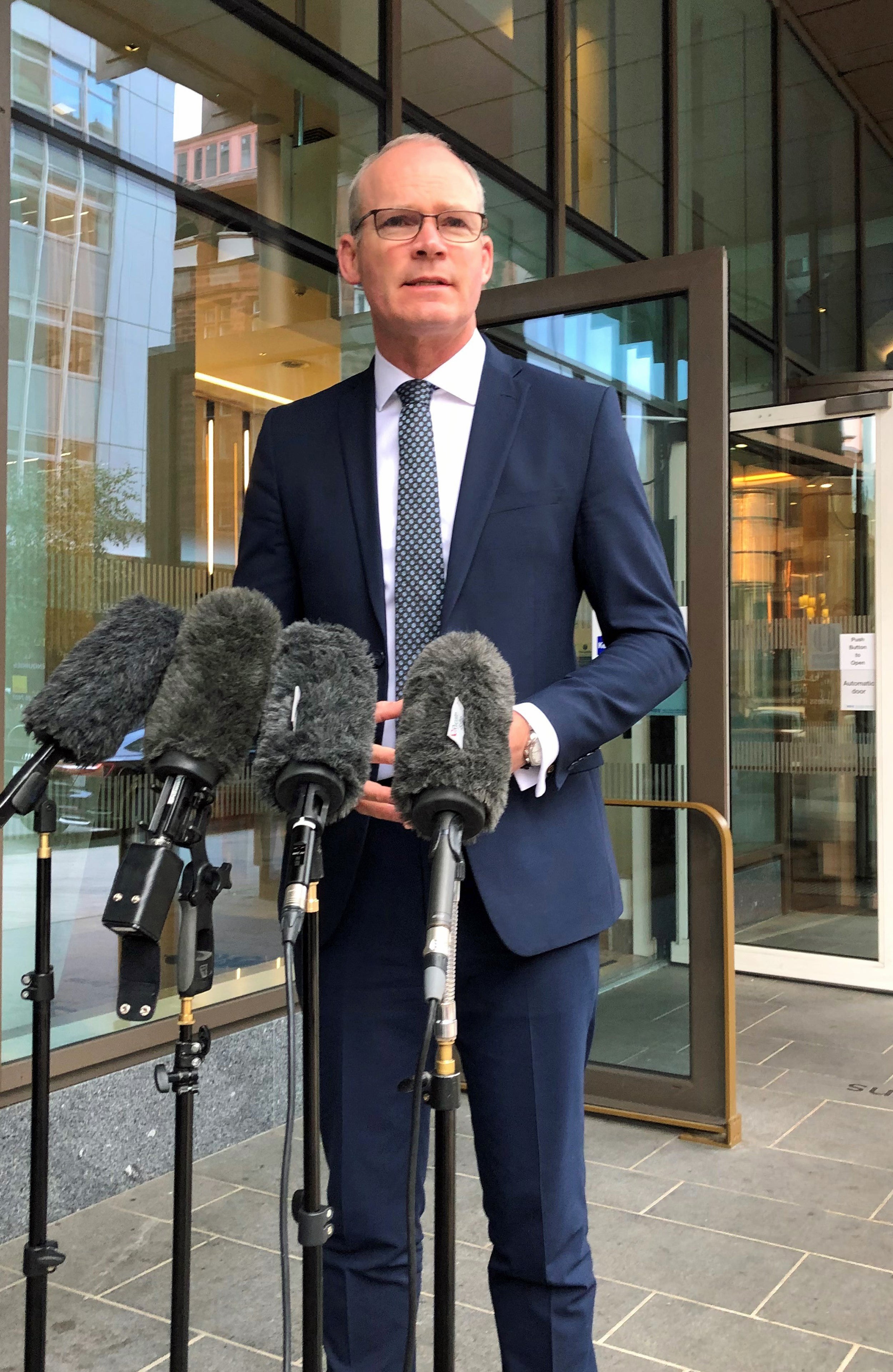 Irish Foreign Affairs Minister Simon Coveney speaks to the media at Grand Central Hotel in Belfast (David Young/PA)