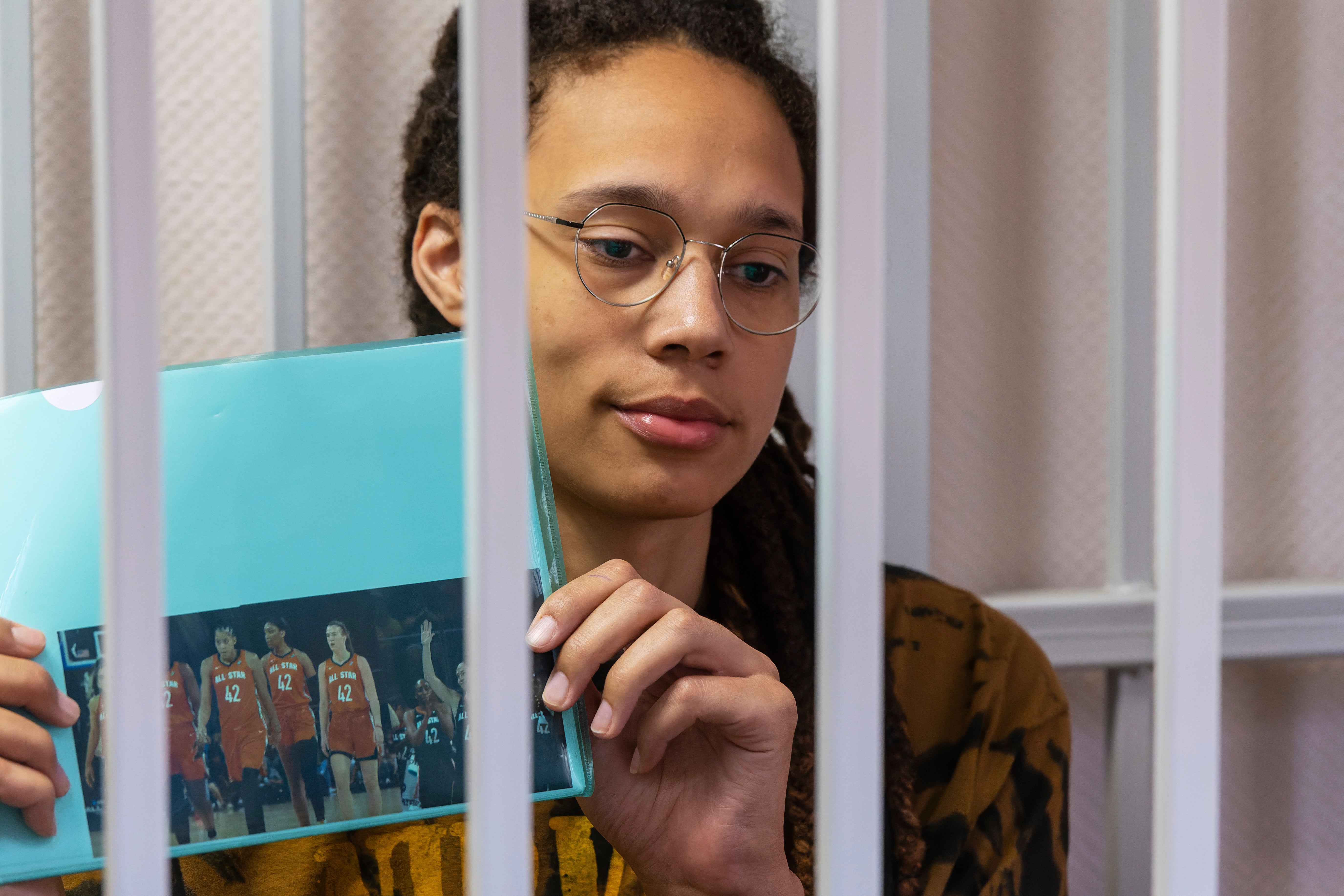 Brittney Griner holds up a photo of players from the recent all star game wearing her number