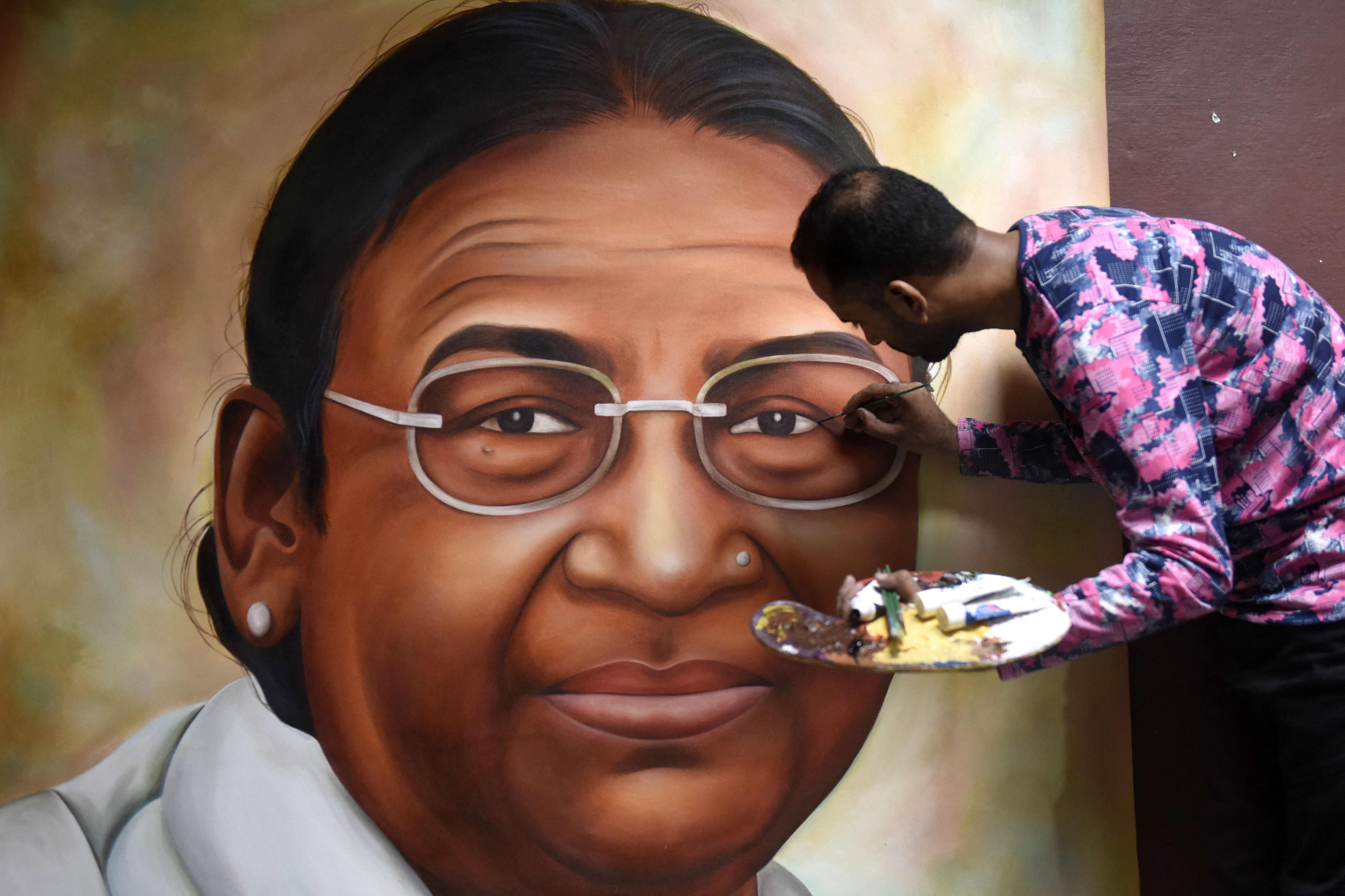 Jagjot Singh Rubal gives final touches to a painting of Bharatiya Janata Party’s (BJP) presidential candidate, Droupadi Murmu, in Amritsar