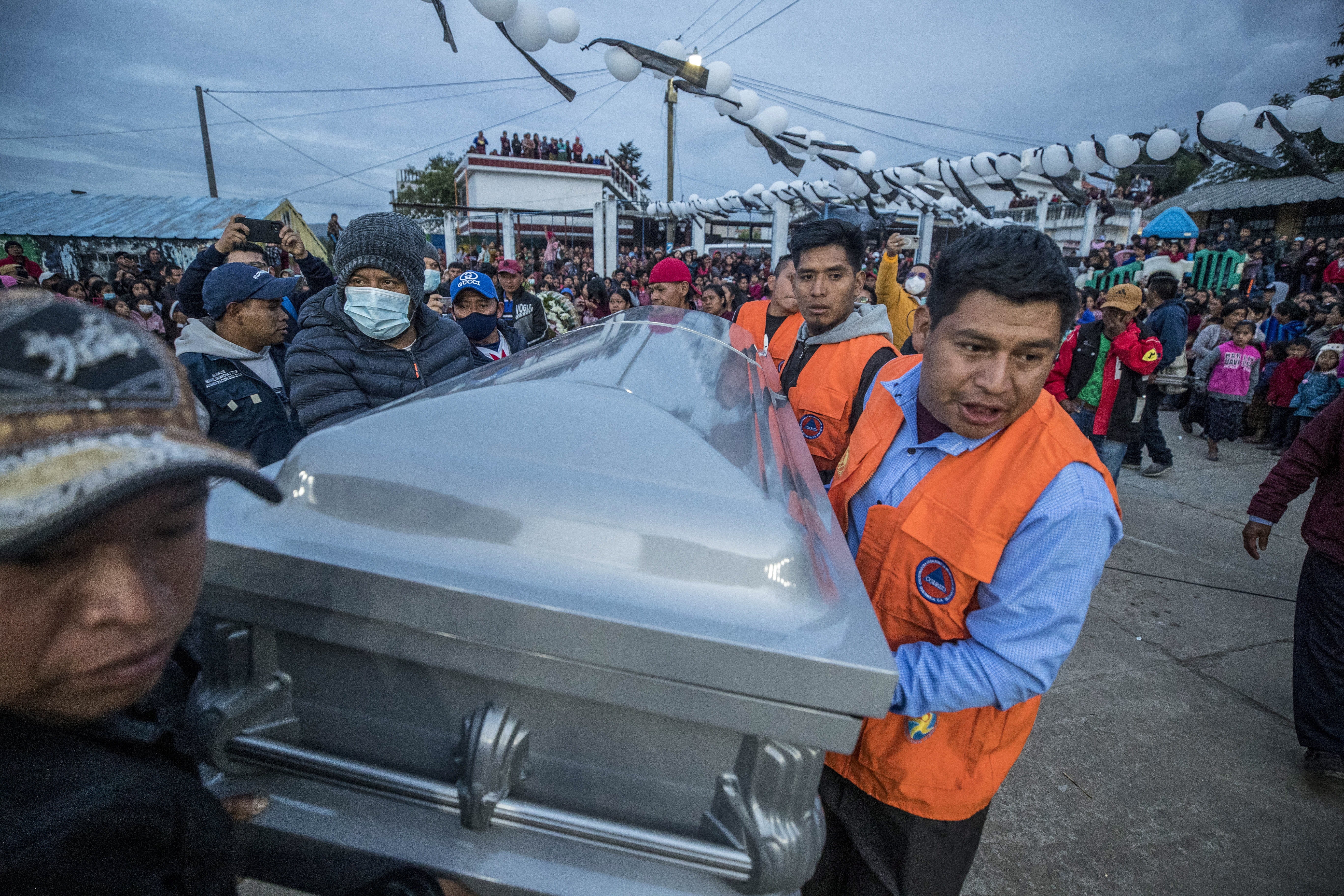 Relatives, friends and neighbors carry the coffin containing the body of Pascual Melvin Guachiac Sipac, 13, who died in the tragedy of 27 June in Texas; in the Tzucubal village, Nahuala, Guatemala, 15 July 2022