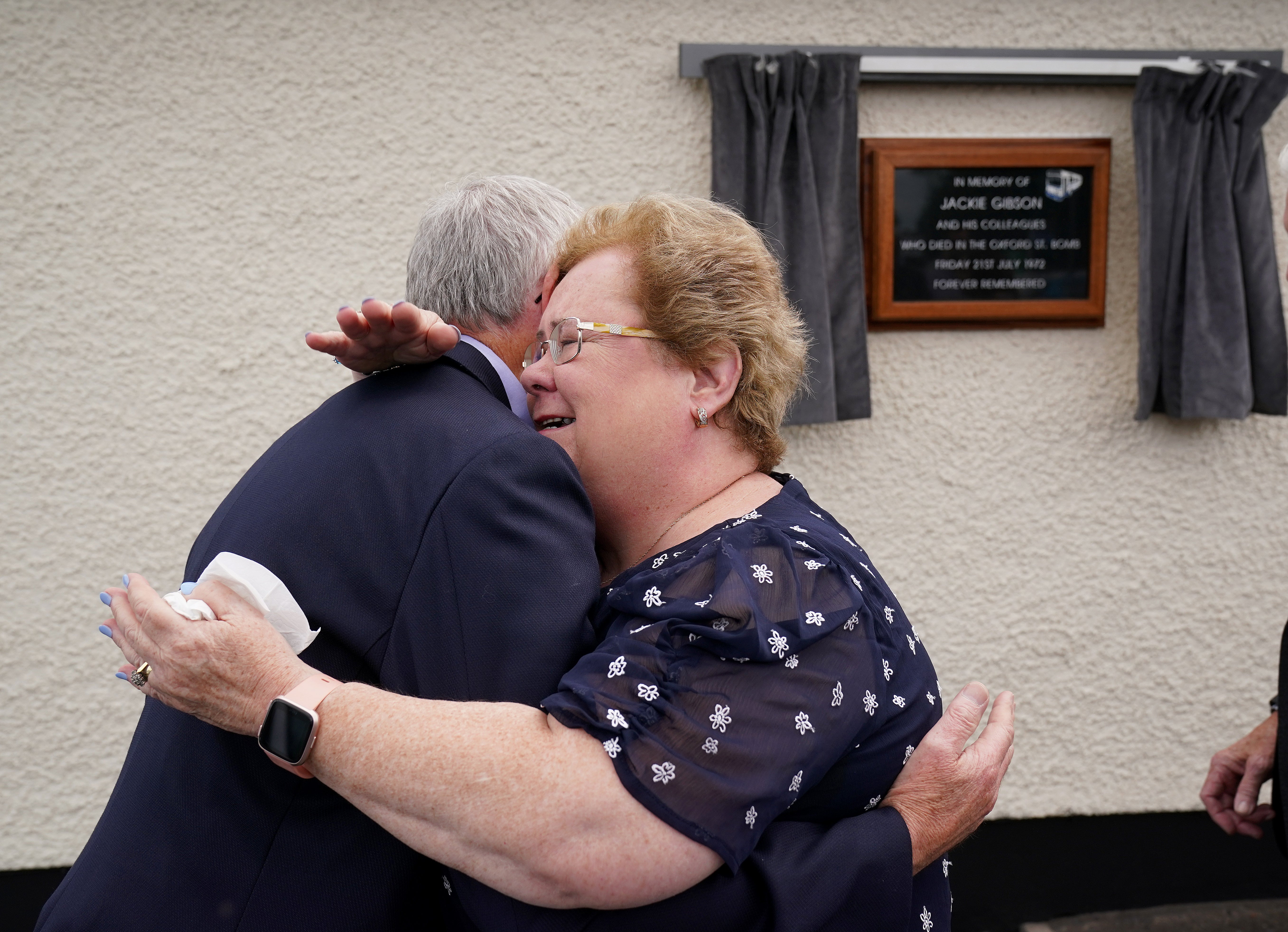 Daughter of bus driver Jackie Gibson Lynda Van Cuylenburg hugs her brother Robert Gibson, at an event with some of their father’s former colleagues in Ulsterbus and current drivers to unveil a plaque at the depot in Ballygowan where he began his journey on Bloody Friday. Jackie was killed in the bomb that detonated at the Oxford Street bus station on July 21 1972. Picture date: Thursday July 21, 2022.