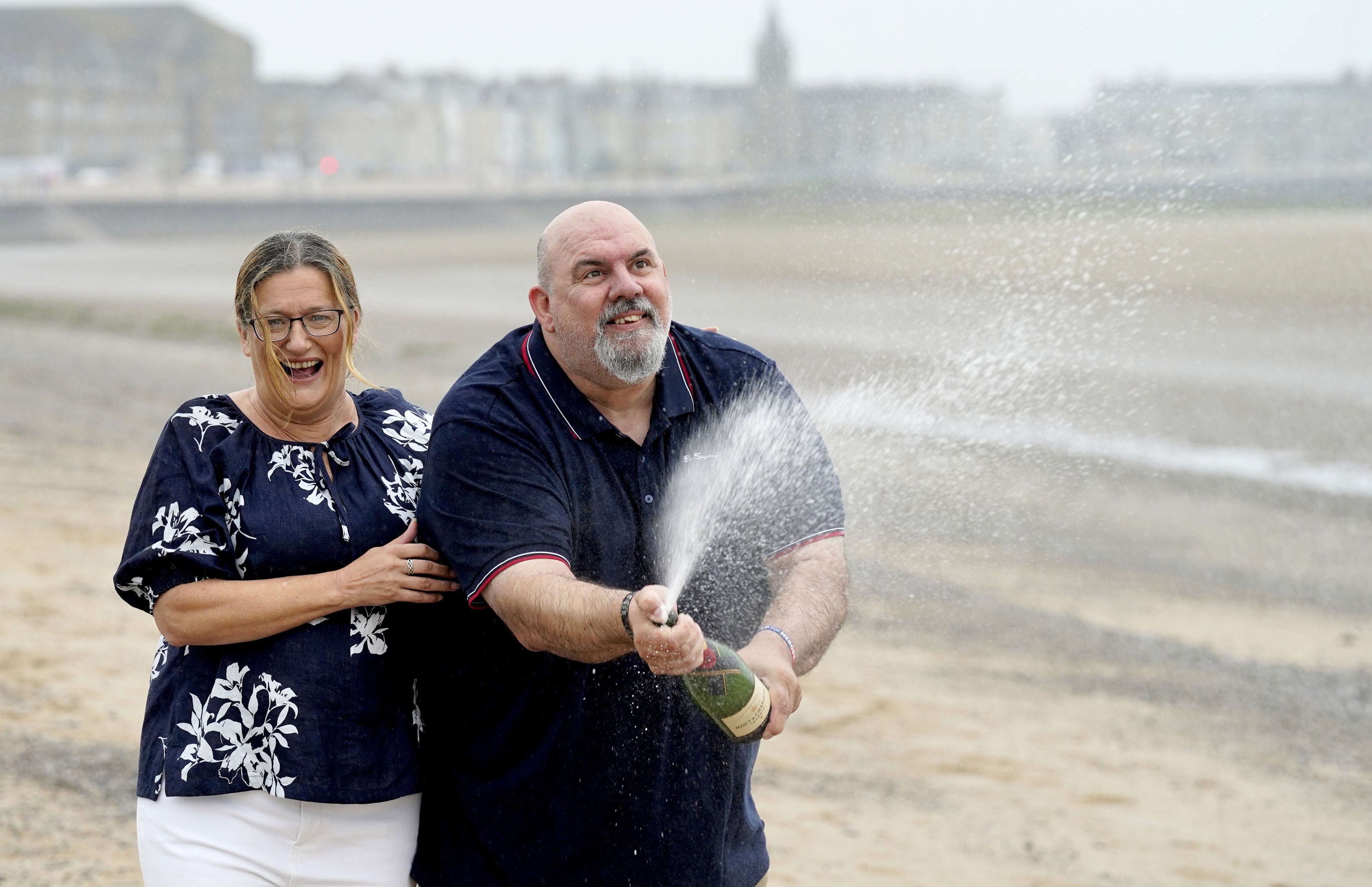 Helen and Lee Kuchczynski, from Cumbria, celebrate their £3.6 million EuroMillions win (Danny Lawson/PA)