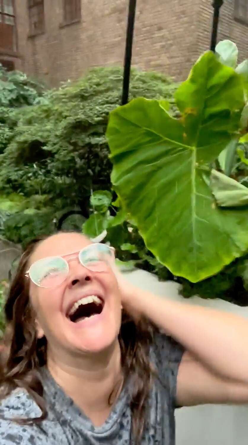 Soggy but sincere: Drew Barrymore sprints through the rain in a recent video on Instagram