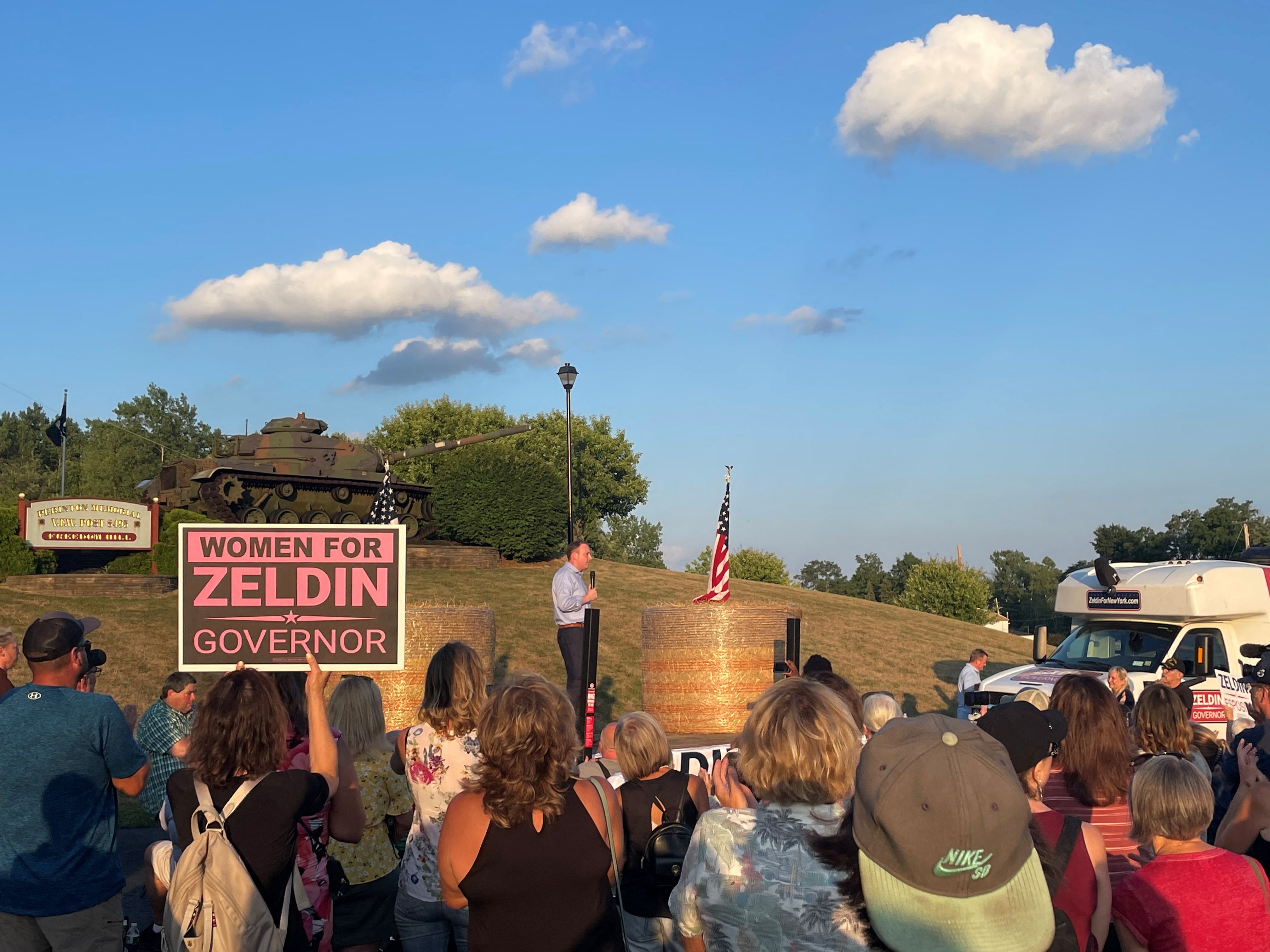 Congressman Lee Zeldin stands on stage after an alleged attack on him during his stump speech, in Fairport, New York, United States, July 21, 2022