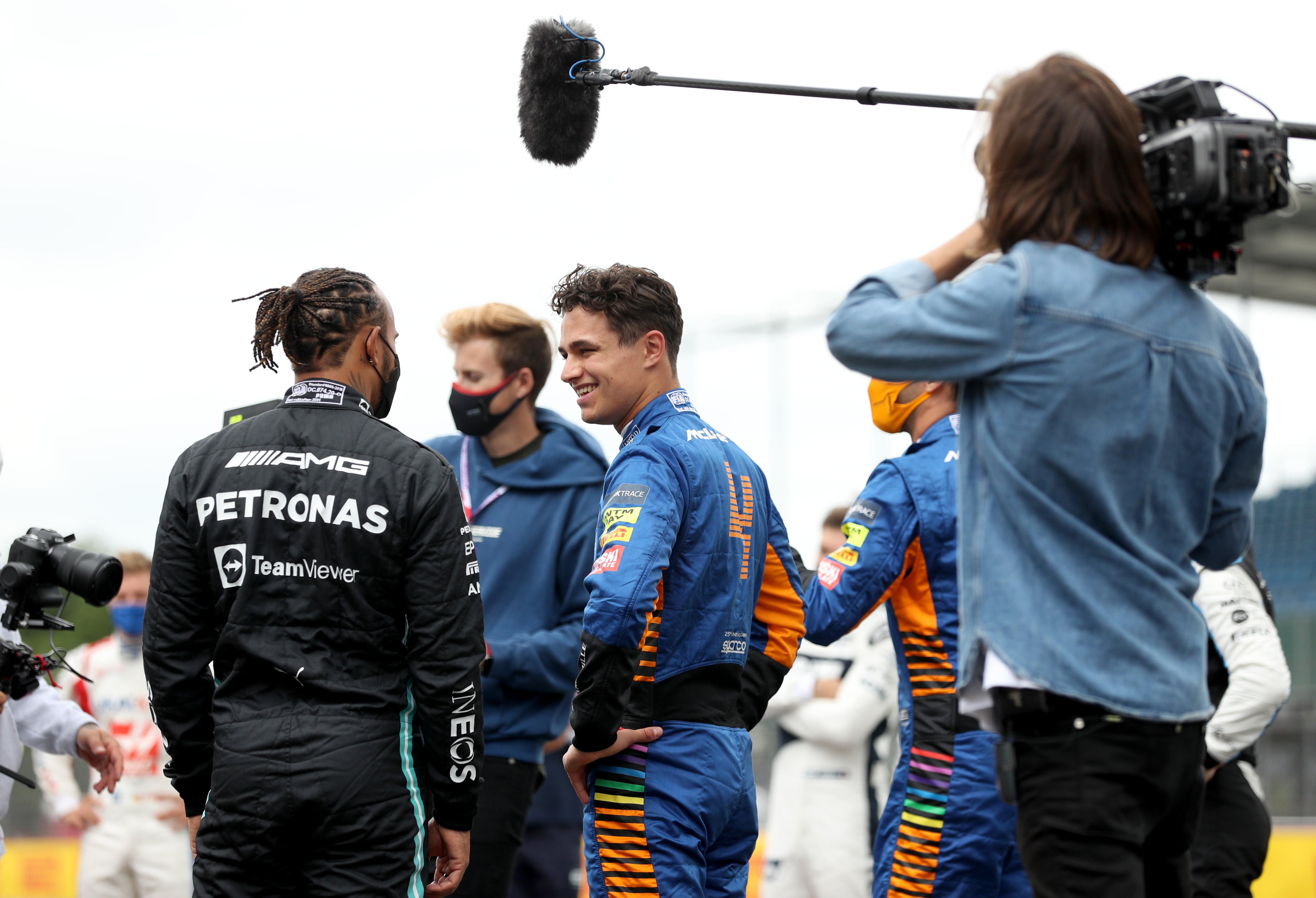 Lewis Hamilton, left, talks with Lando Norris in the paddock ahead of the British Grand Prix (Bradley Collyer/PA)