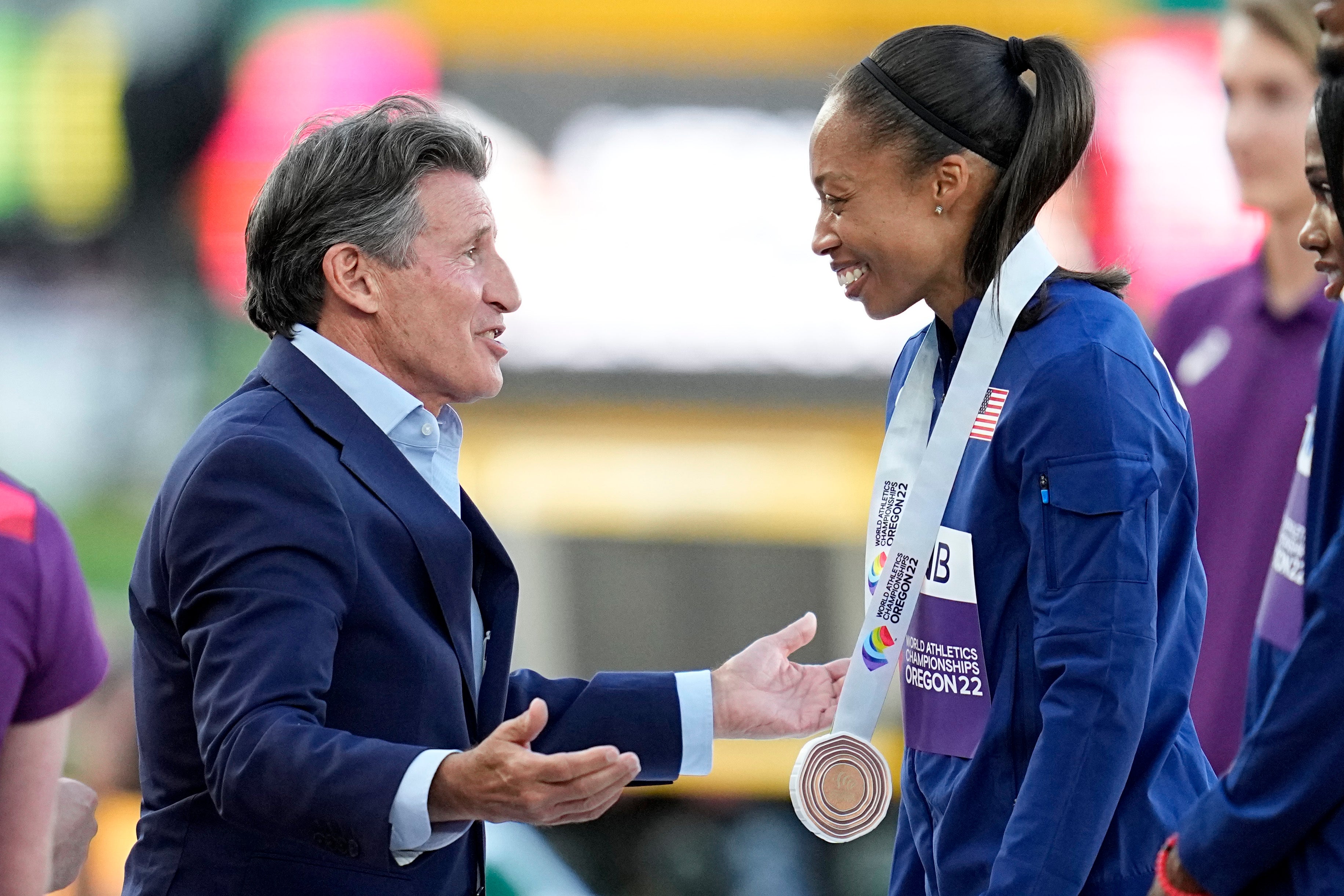 Lord Coe gives a bronze medal to Allyson Felix (Ashley Landis/AP)