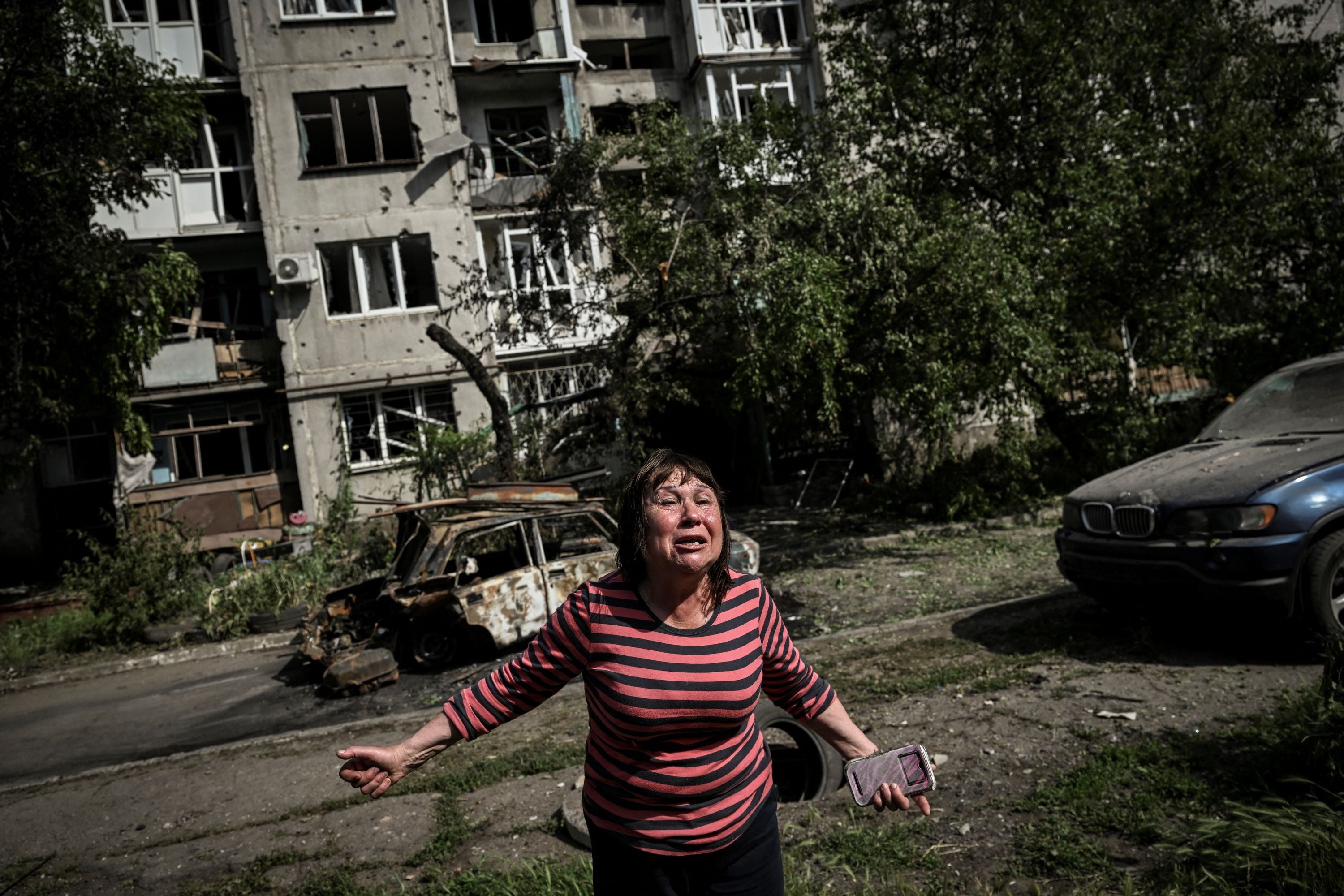 A woman reacts following a missile strike close to an apartment building in the city of Slovyansk