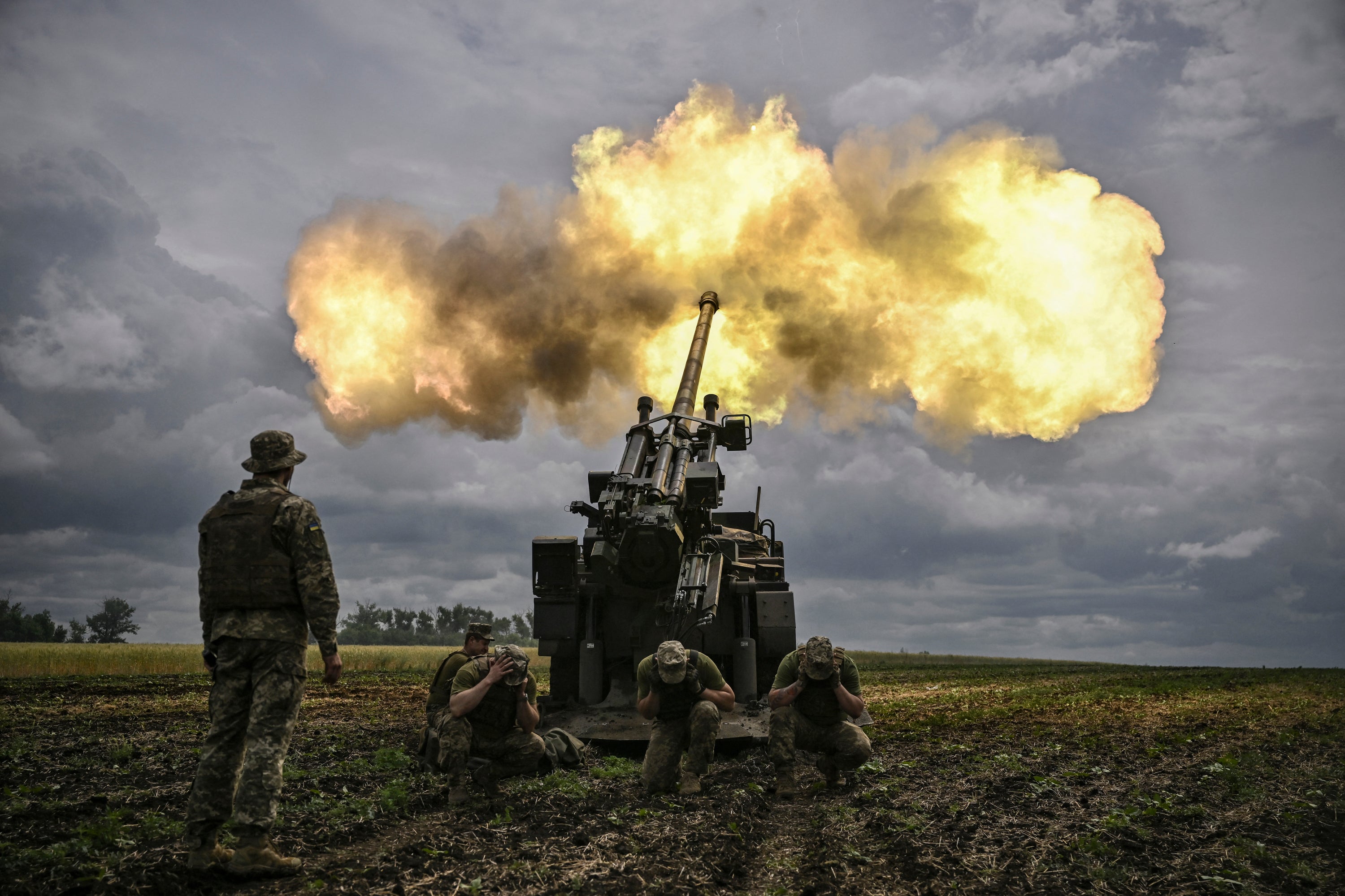 Ukrainian servicemen fire from a Caesar howitzer at Russian positions on the front line in the Donbas