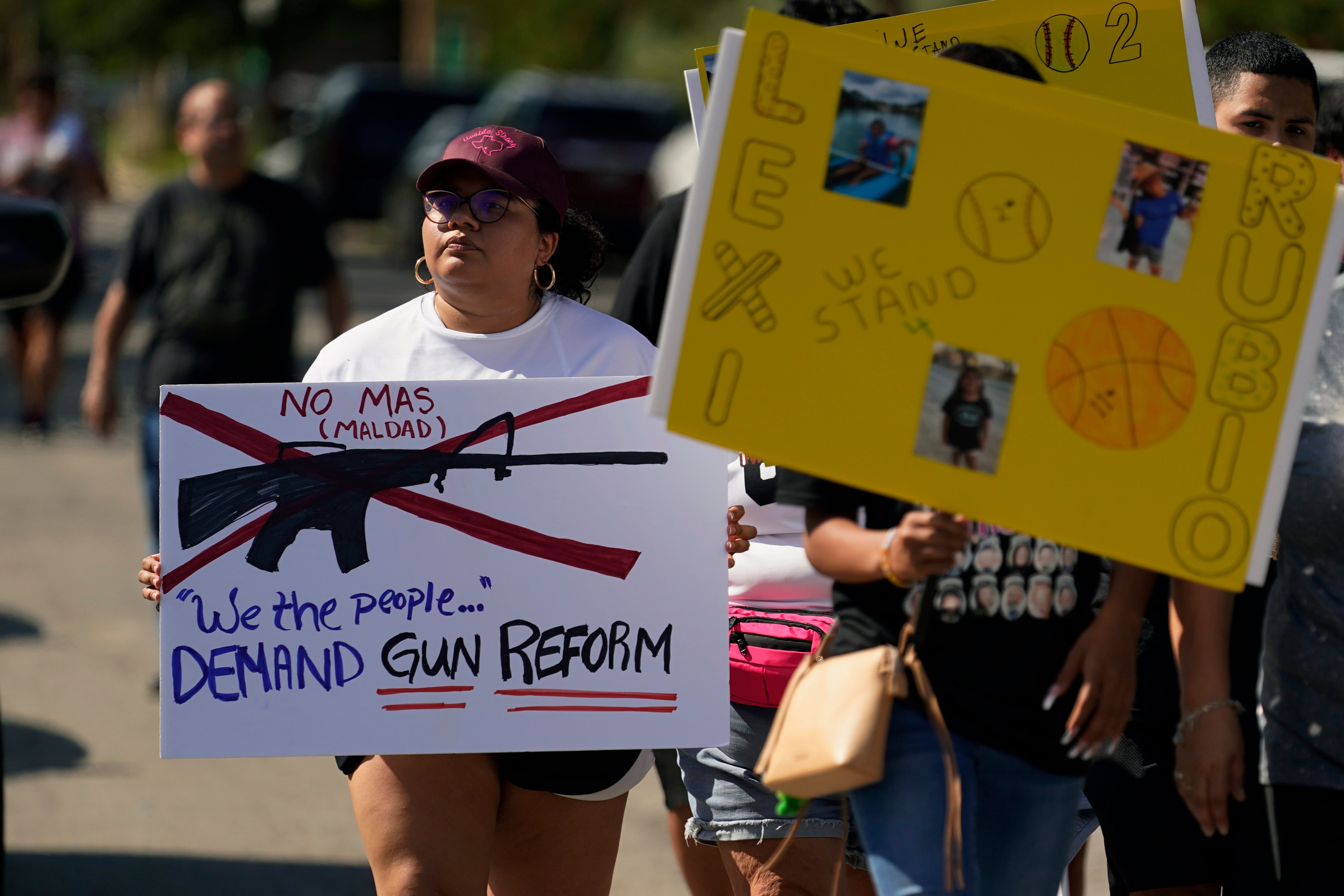 Family and friends of those killed and injured in the school shootings take part in a protest march