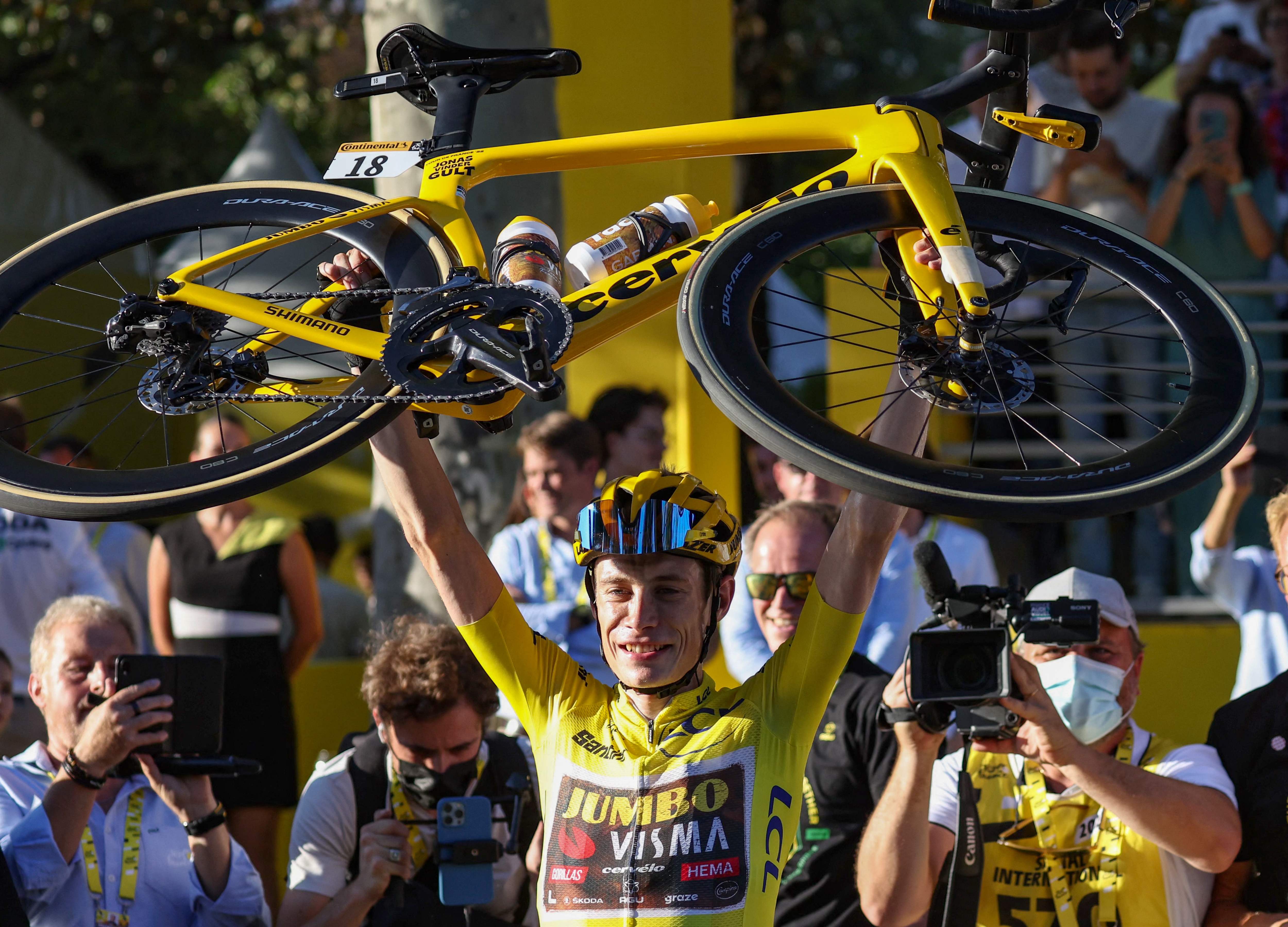 Vingegaard raises his bicycle after winning the 109th edition of the Tour de France