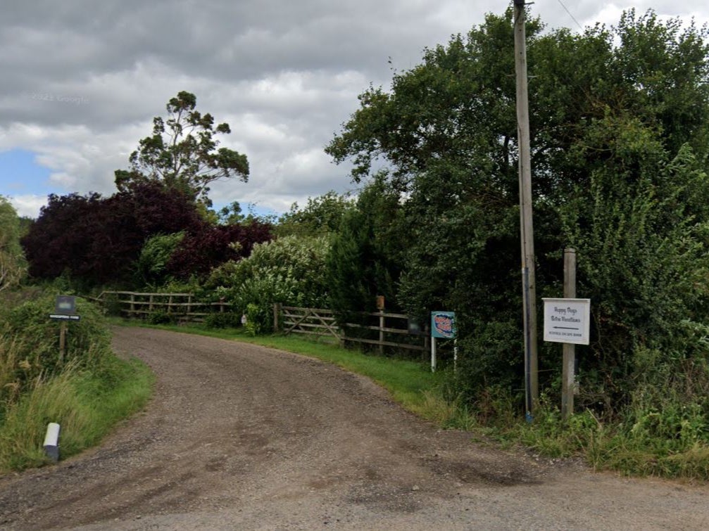 A mother was killed and her partner and two children rushed to hospital after a fire tore through their caravan during a glamping trip