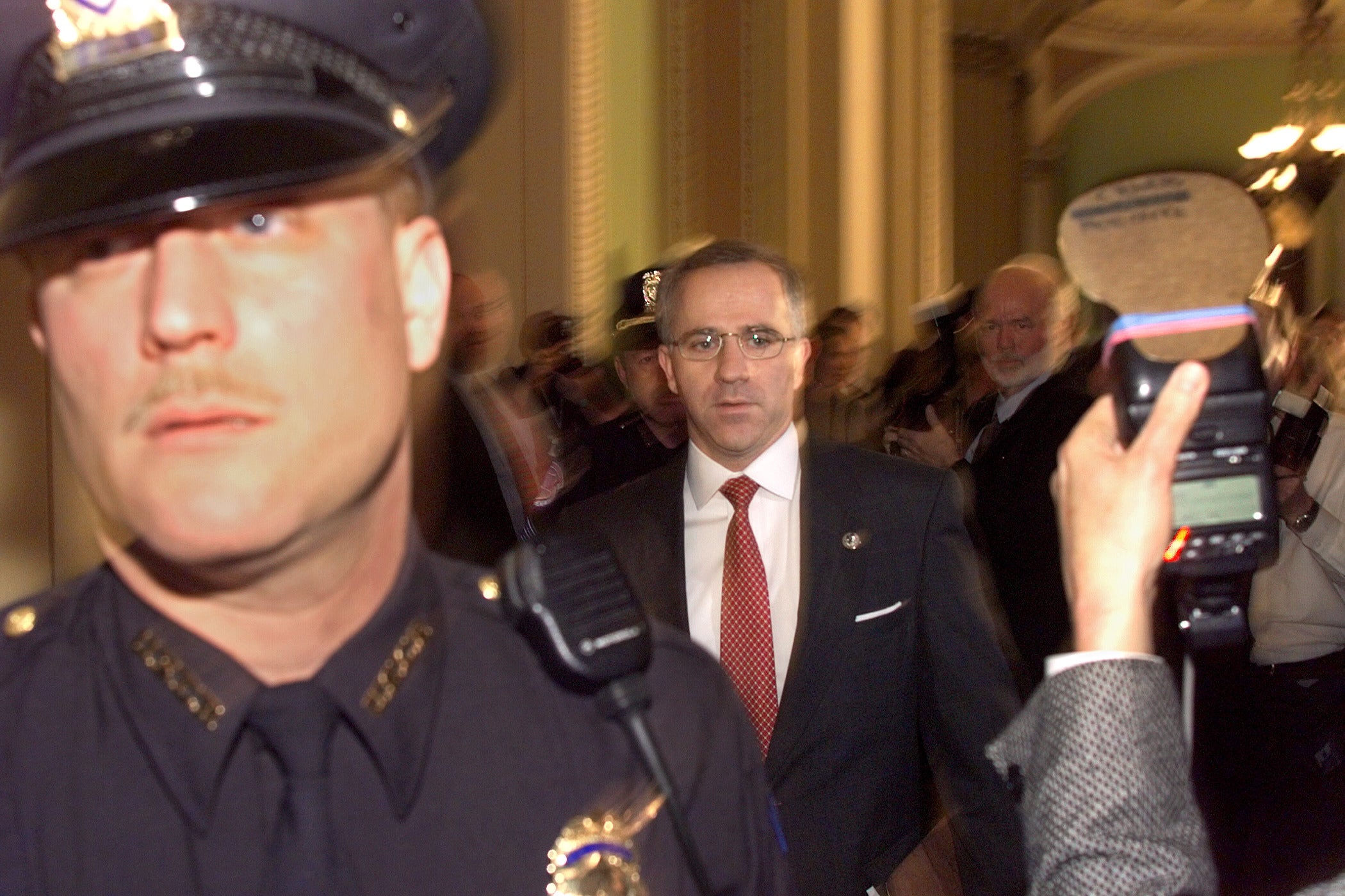 Steve Buyer (R-IN) walks in the halls of the US Senate as Capitol Hill police hold back the media in the halls of the US Senate shortly before the start of the 14 January impeachment trial of US President Bill Clinton