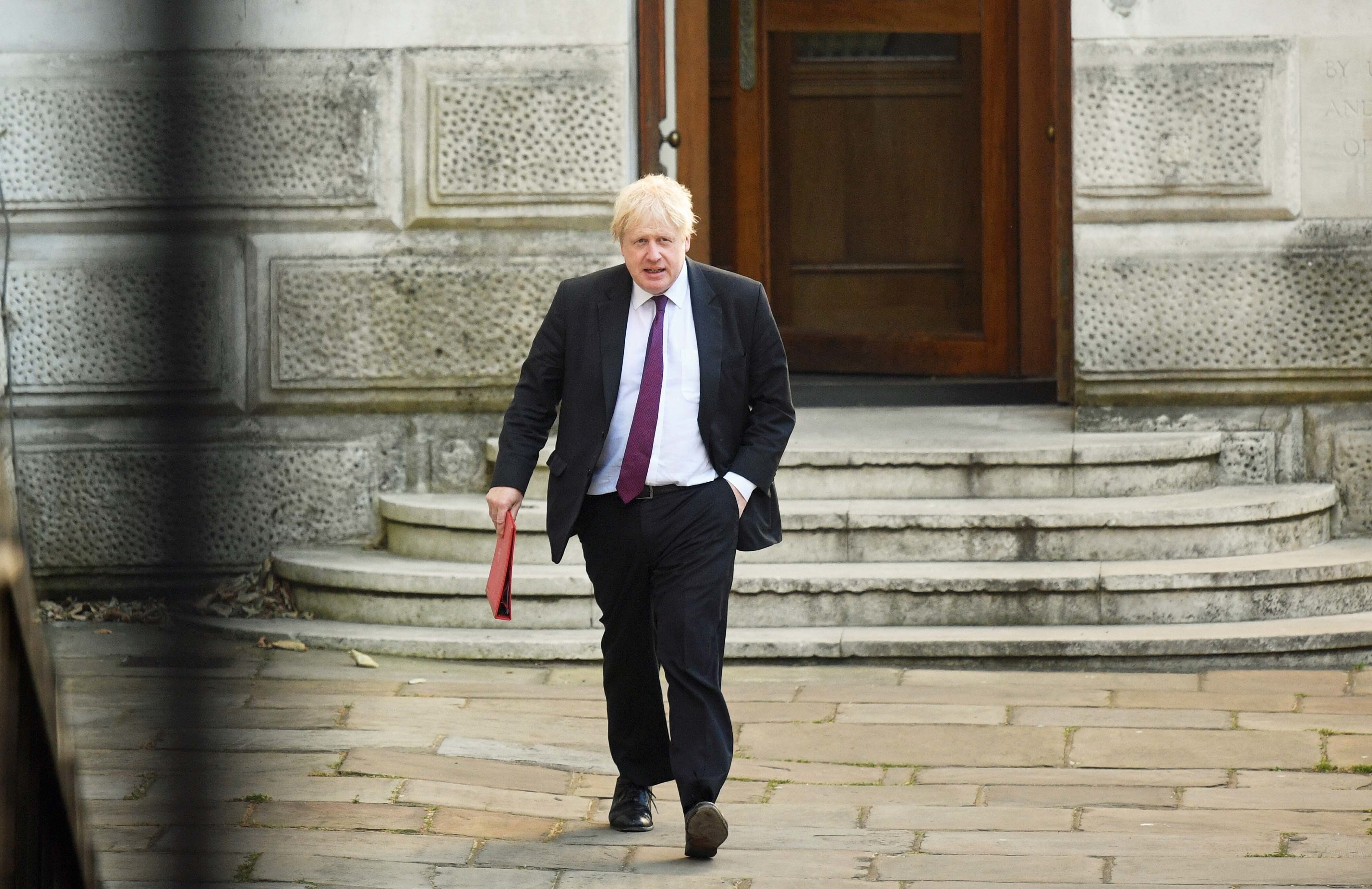 Then foreign secretary Boris Johnson leaves the Foreign Office (Victoria Jones/PA)