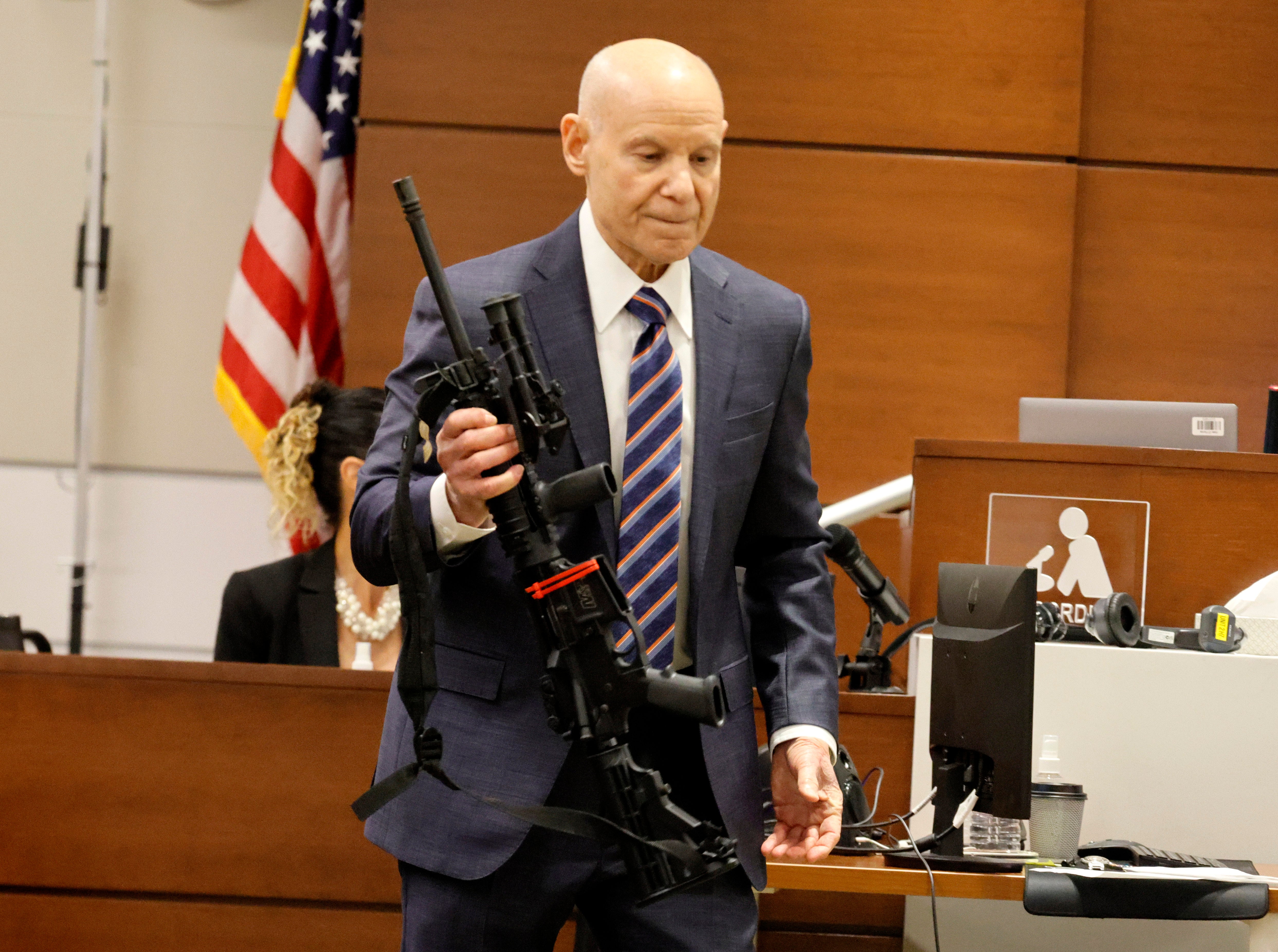 Assistant State Attorney Mike Satz checks into evidence the weapon used in Parkland's Marjory Stoneman Douglas High School shooting during the penalty phase of Nikolas Cruz at the Broward County Courthouse in Fort Lauderdale on Monday, July 25, 2022