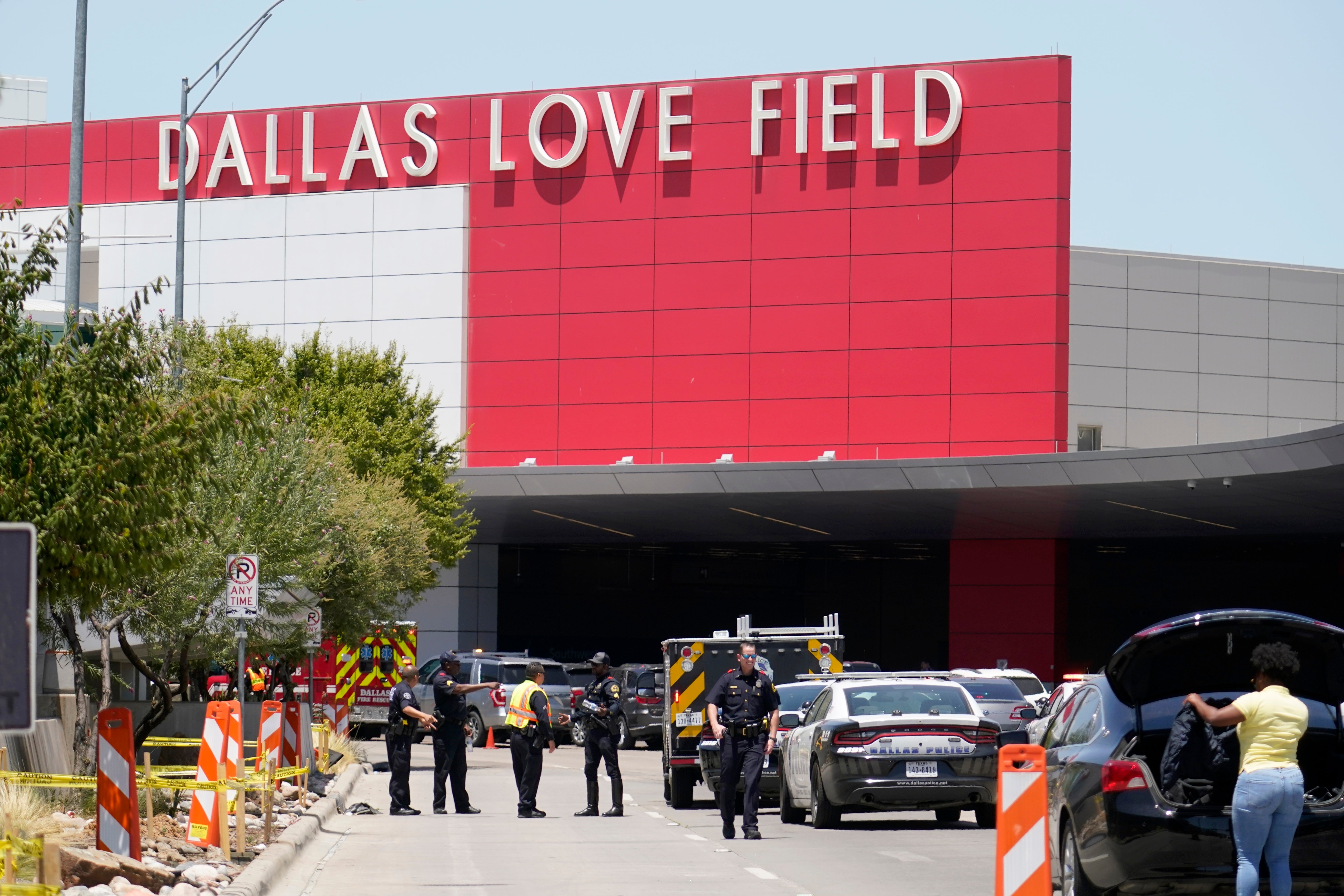 Emergency responders converge near the main entrance at Dallas Love Field in Dallas, Monday, July 25, 2022