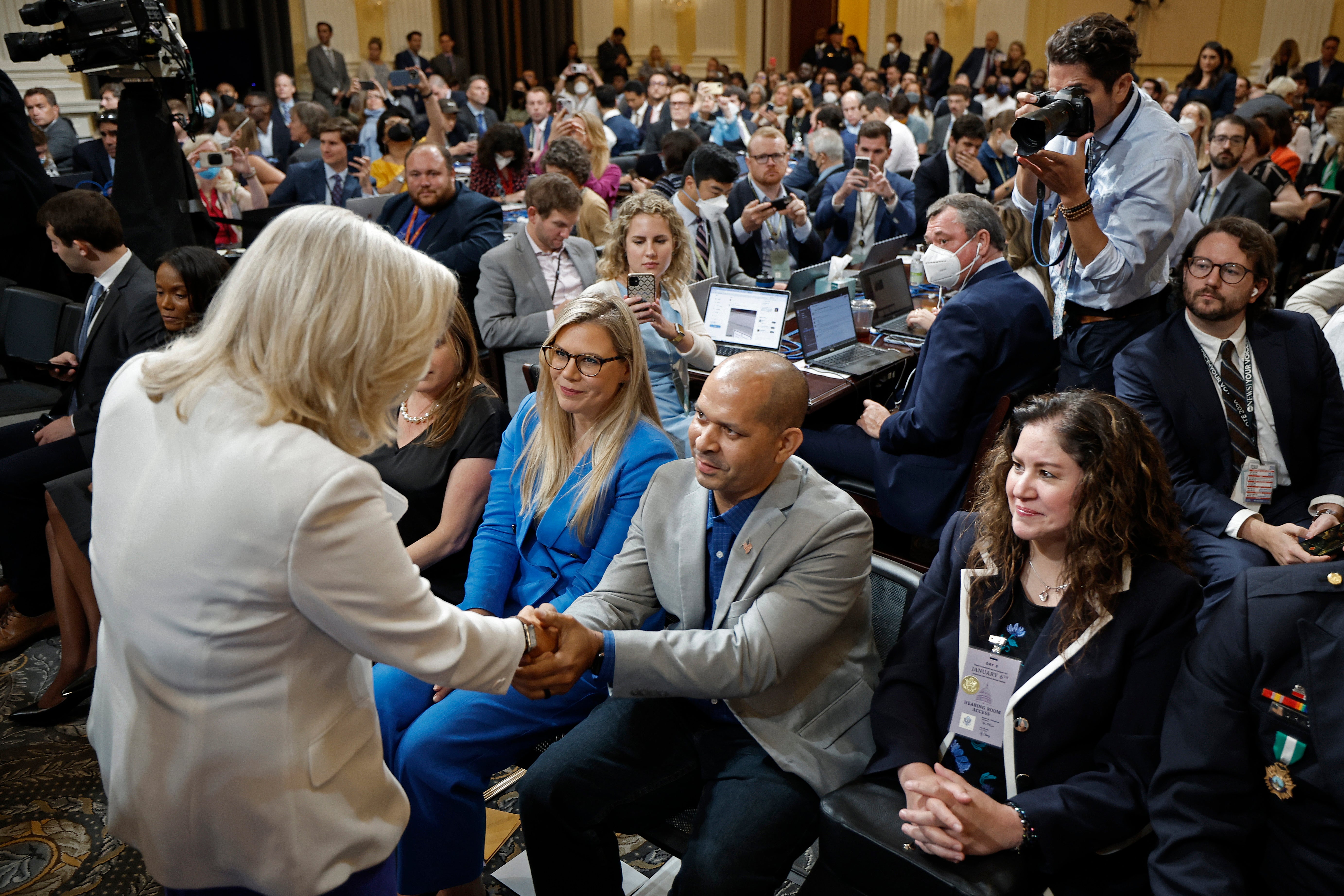 Rep. Liz Cheney (R-WY), Vice Chairwoman of the House Select Committee to Investigate the January 6th Attack on the U.S. Capitol, shakes hands with former U.S. Capitol Police Officer Aquilino Gonell