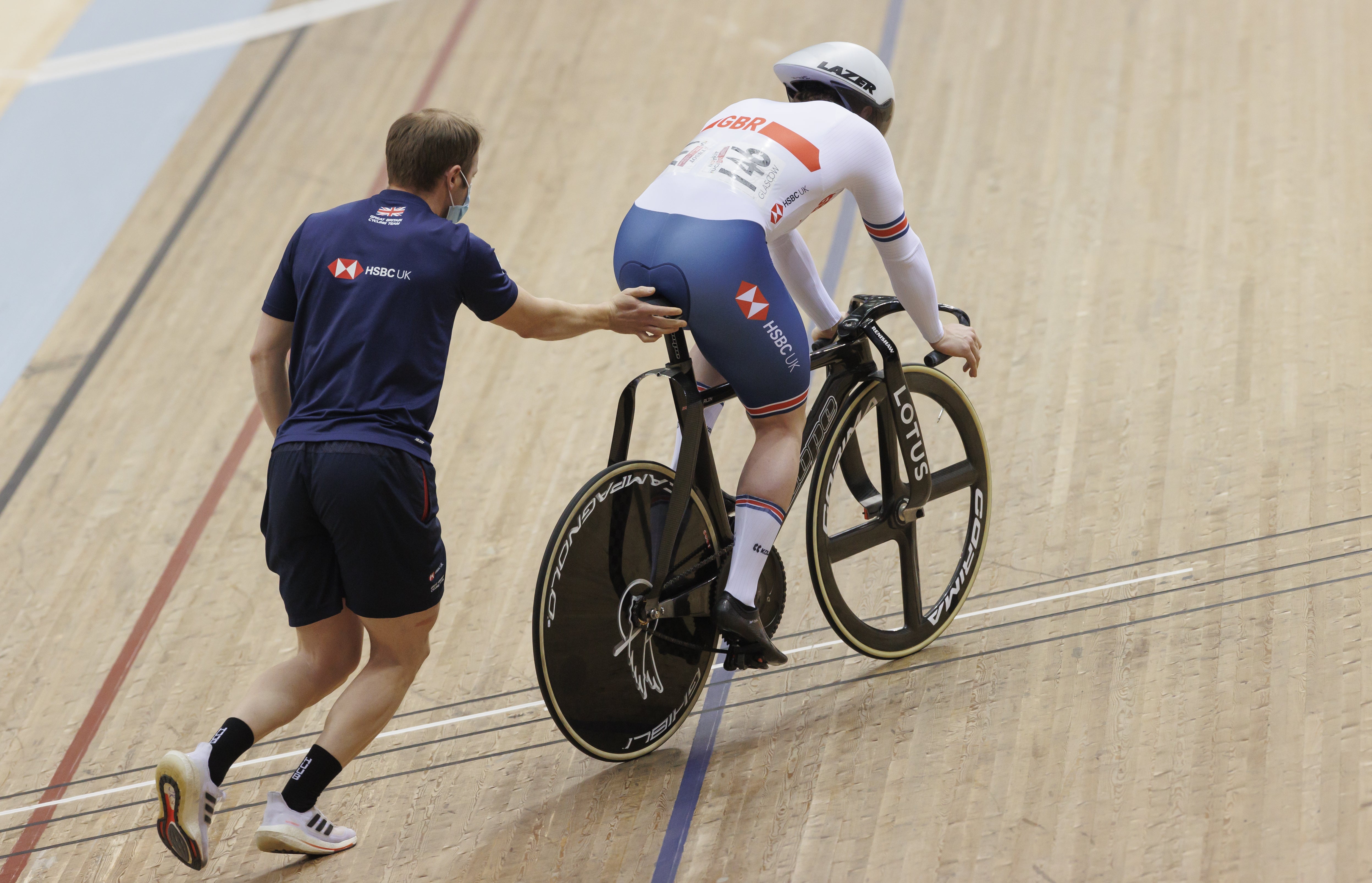 Sir Jason Kenny, left, pushed Jack Carlin to the start line during the UCI Nations Cup in Glasgow in April (Steve Welsh/PA)