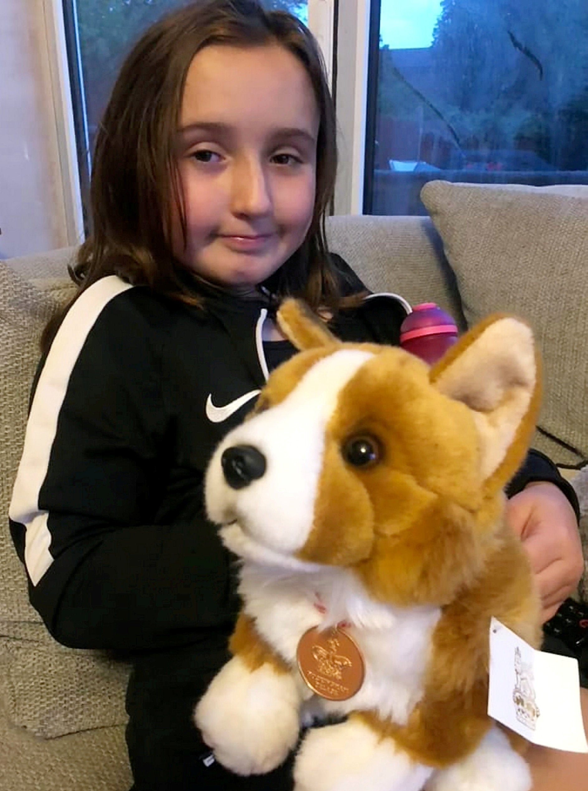 Georgie with her stuffed Corgi, gifted to her by palace staff