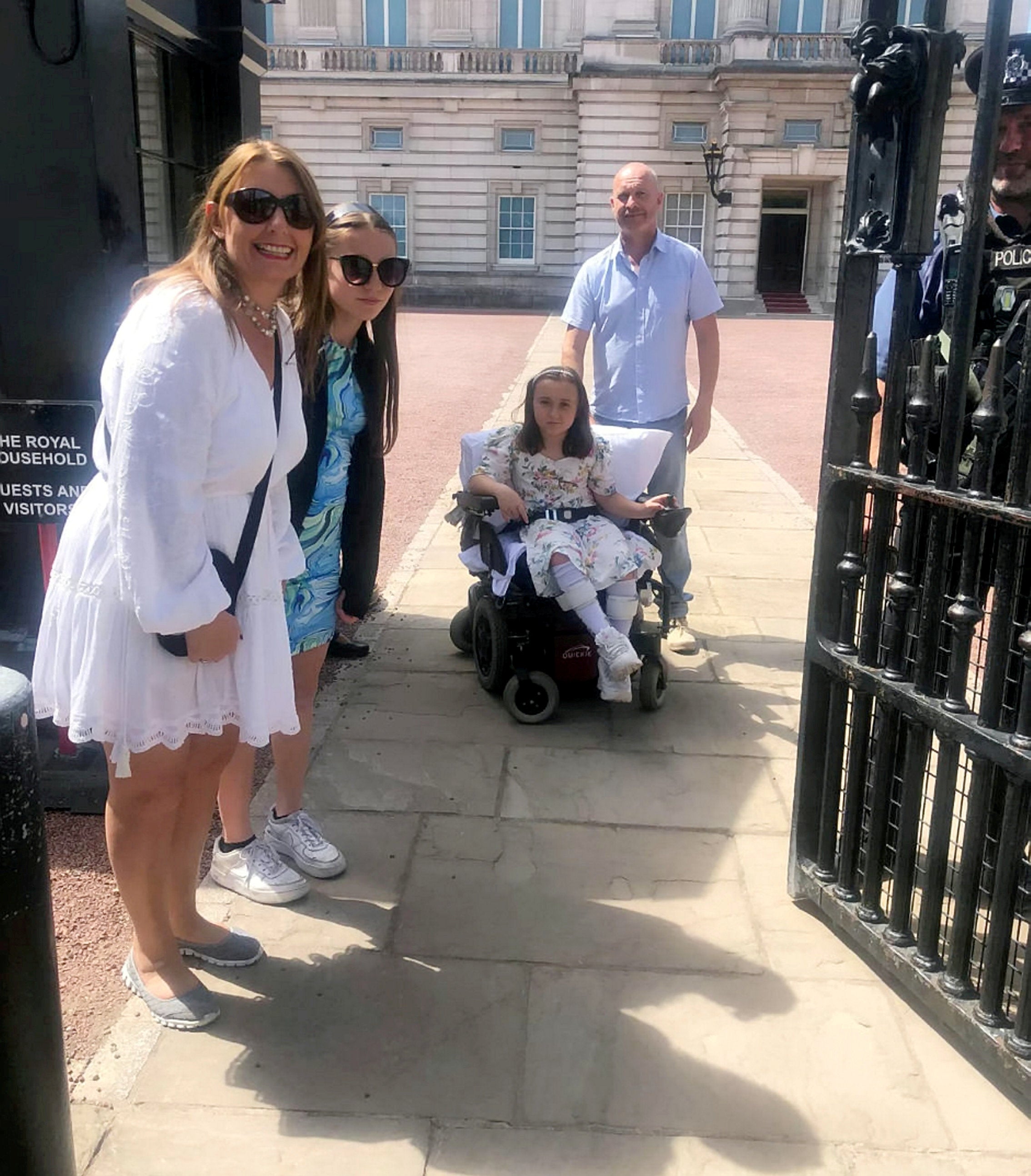 Georgie at Buckingham Palace, with Clare Gibbs - her mother’s partner Bruce - and her sister Ella, 11