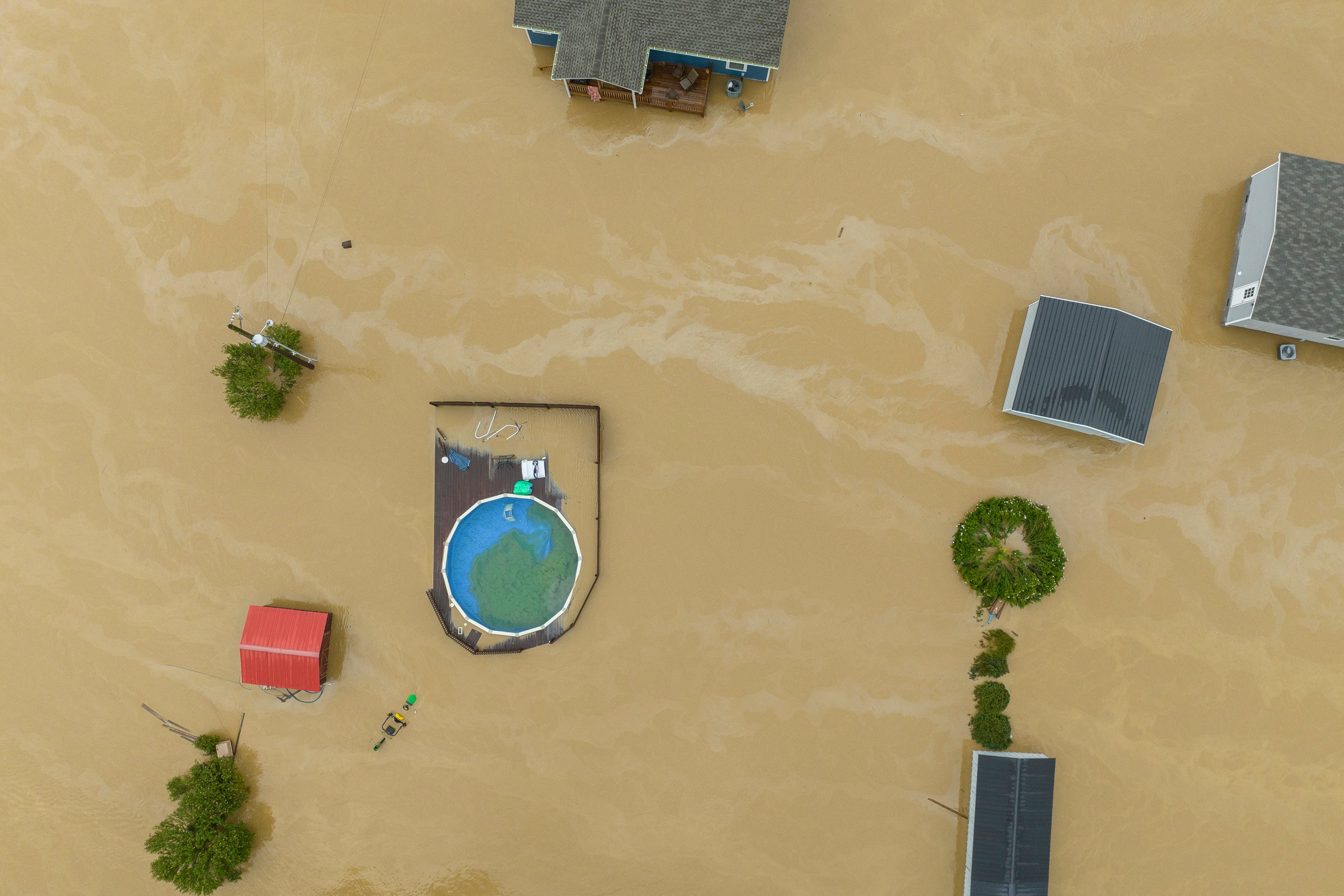 Aerial image of a flooded residential area in Quicksand, Kentucky, as homes are surrounded by intense floodwaters