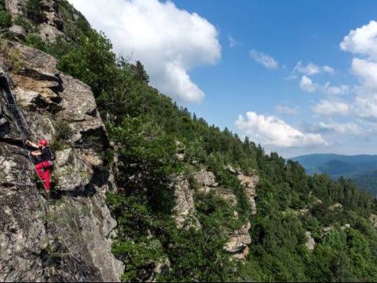 An alpinist climbs a via ferrata in northwestern Italy