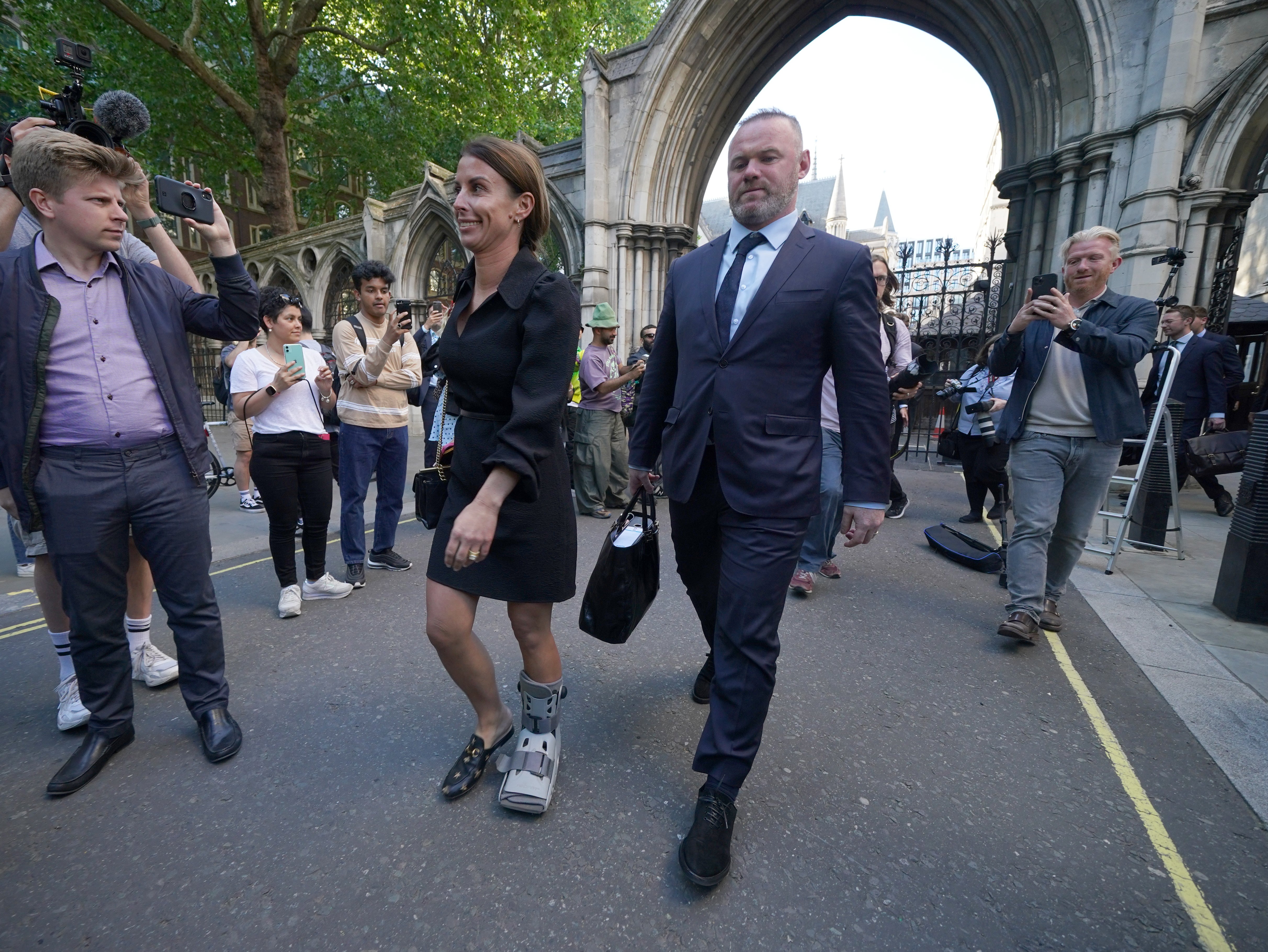 Wayne Rooney carrying wife Coleen’s handbag at the Wagatha trial