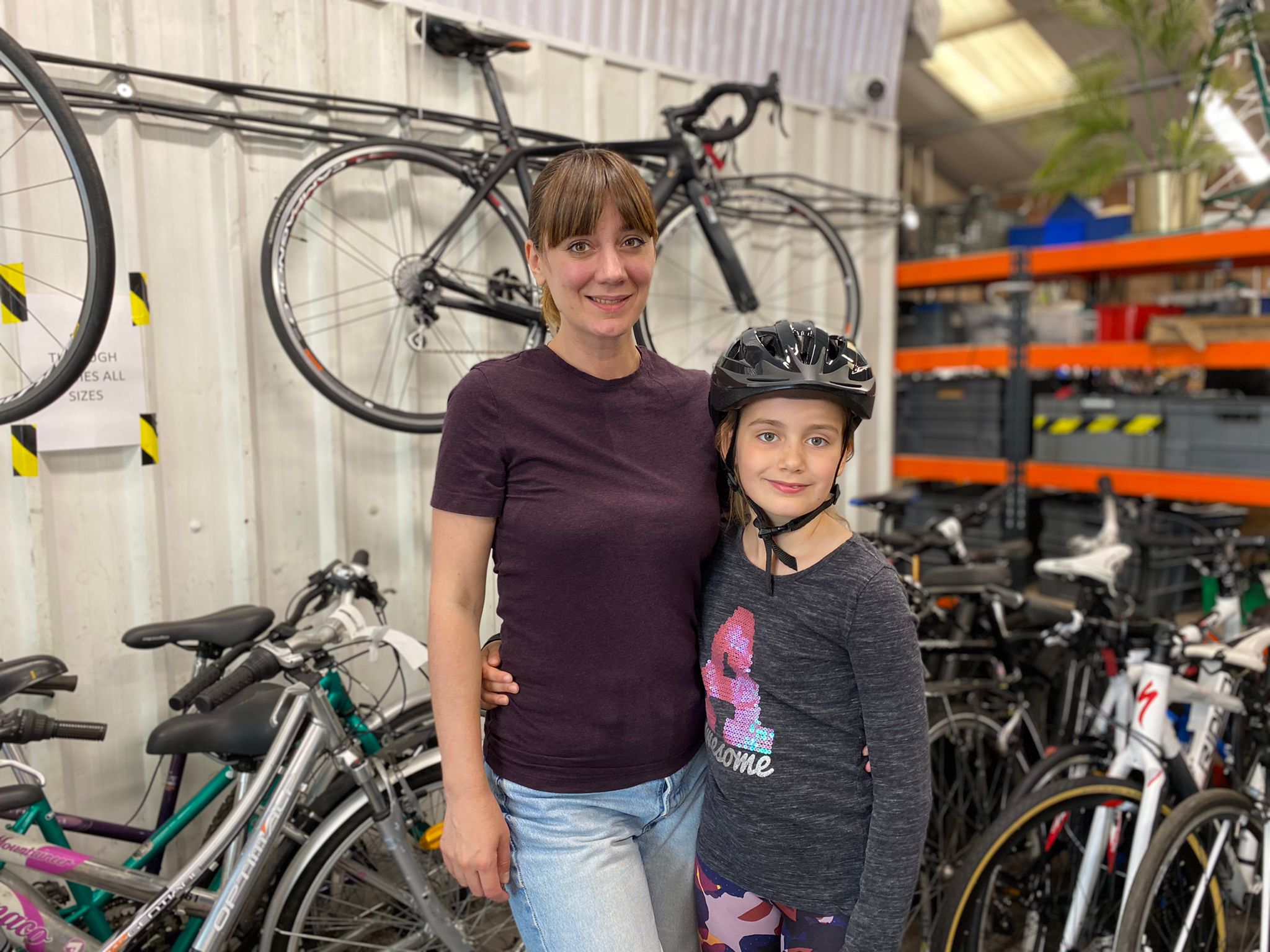 Kateryna Herych, 38, and her eight-year-old daughter Daniella Googe have both received a bike from the charity (PA)