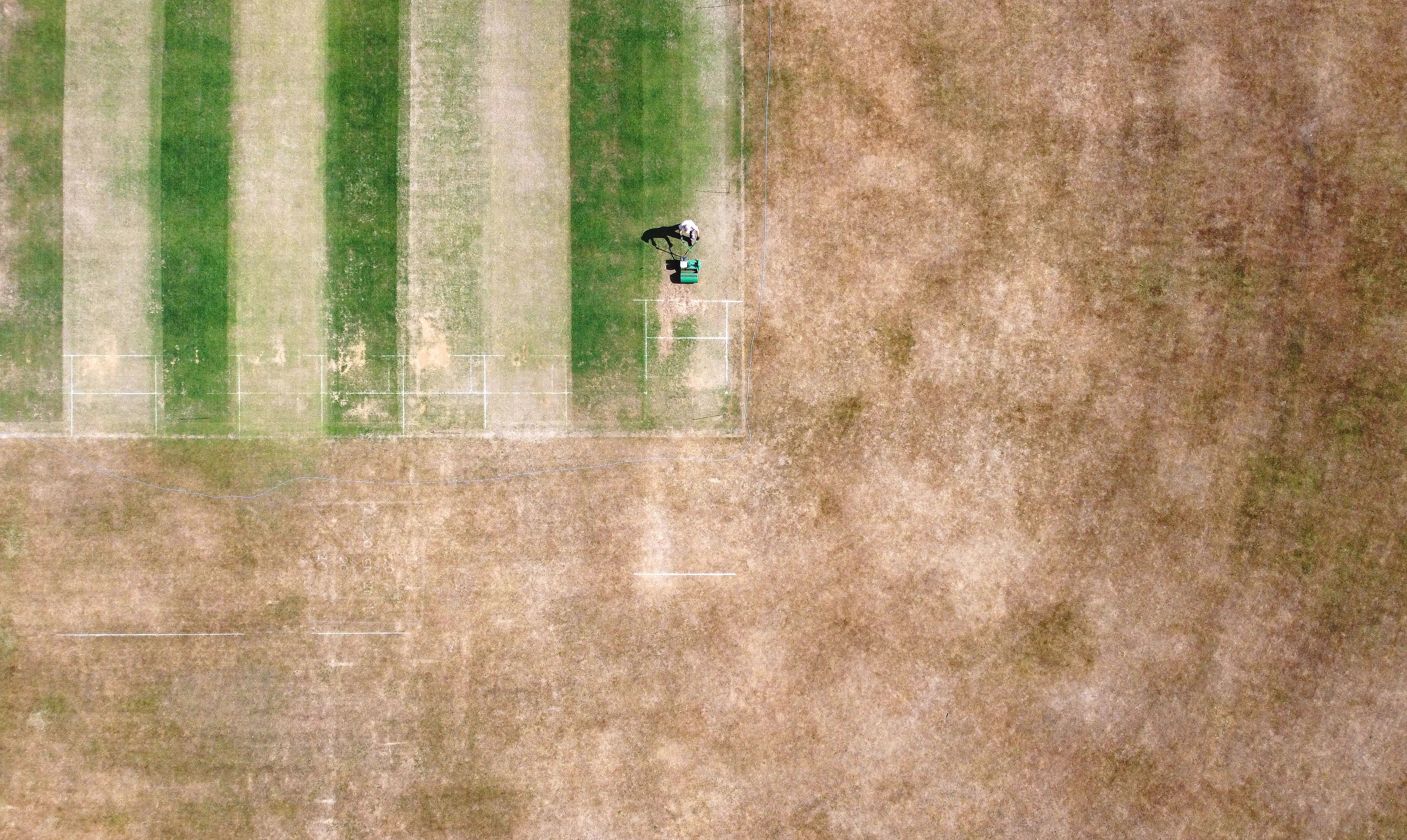 A groundsman at Boughton and Eastwell Cricket Club in Ashford, Kent, prepares the wickets for matches this weekend.