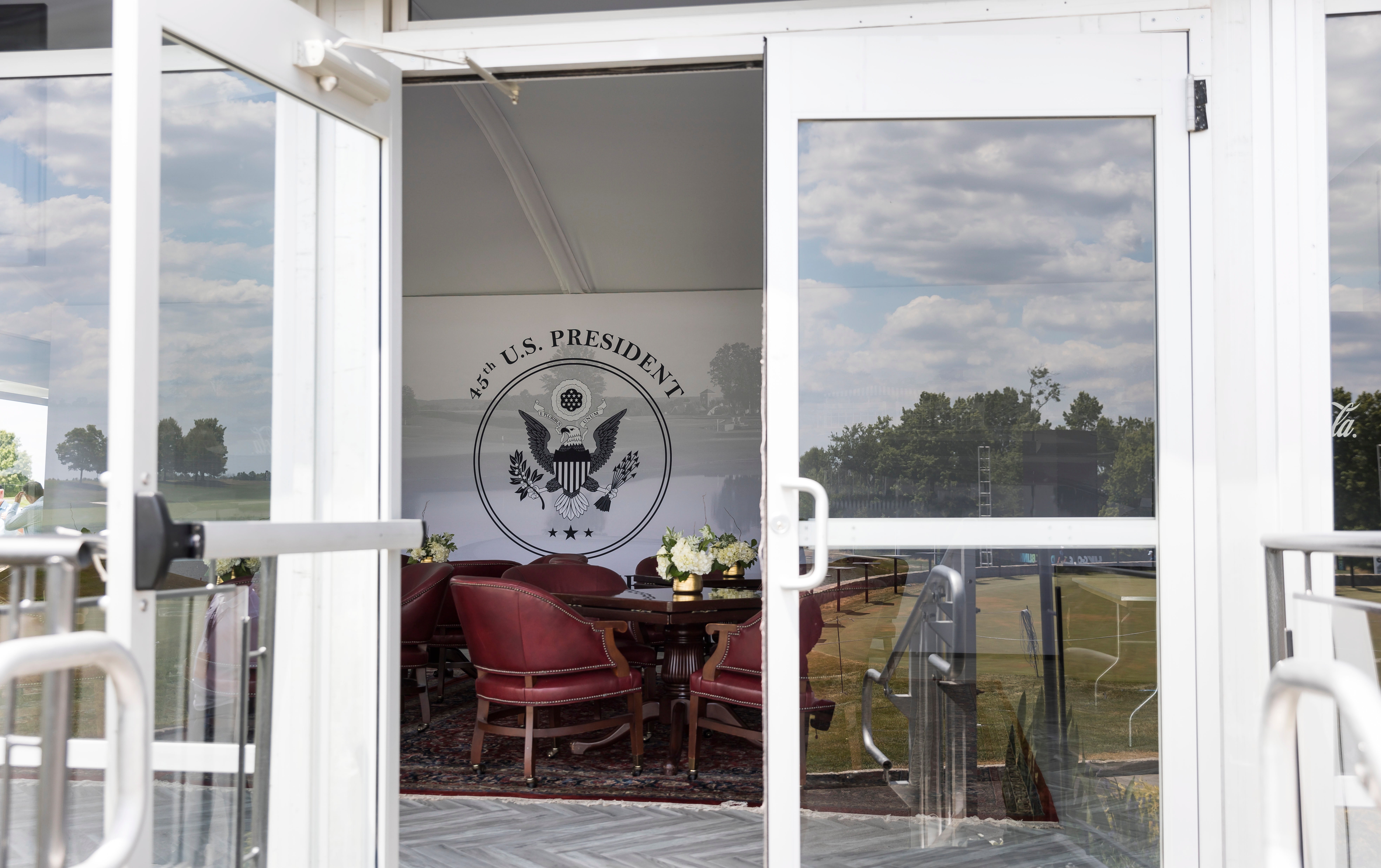 A viewing room in a tent at the 18th green with the US Presidential Seal at the LIV Golf Bedminster