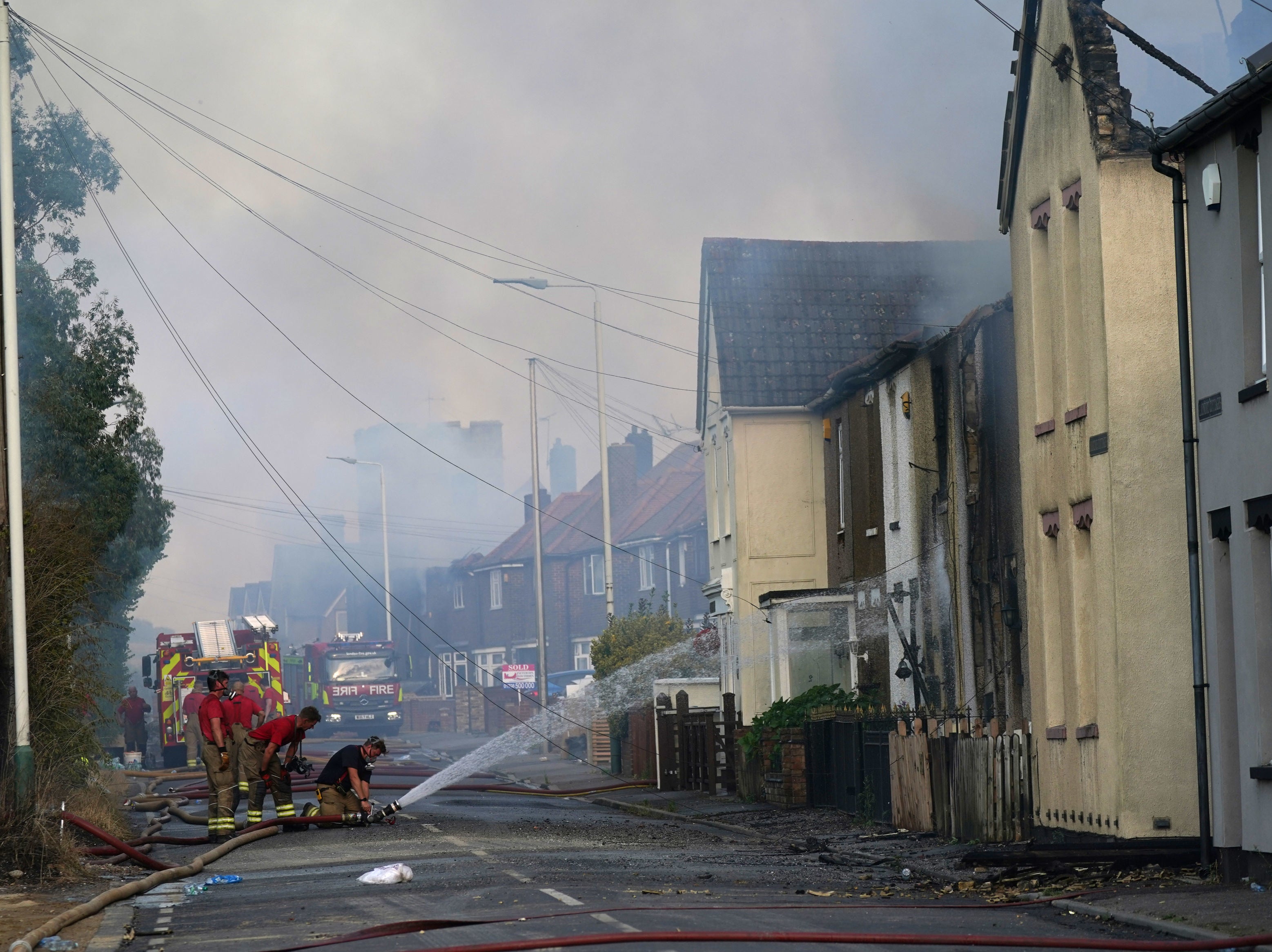 Firefighters at the scene of a blaze in the village of Wennington, east London, during this month’s heatwave