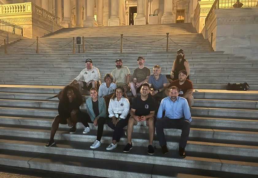 Rosie Torres (centre) with members of the veteran community and lawmakers during the sit in at the Capitol