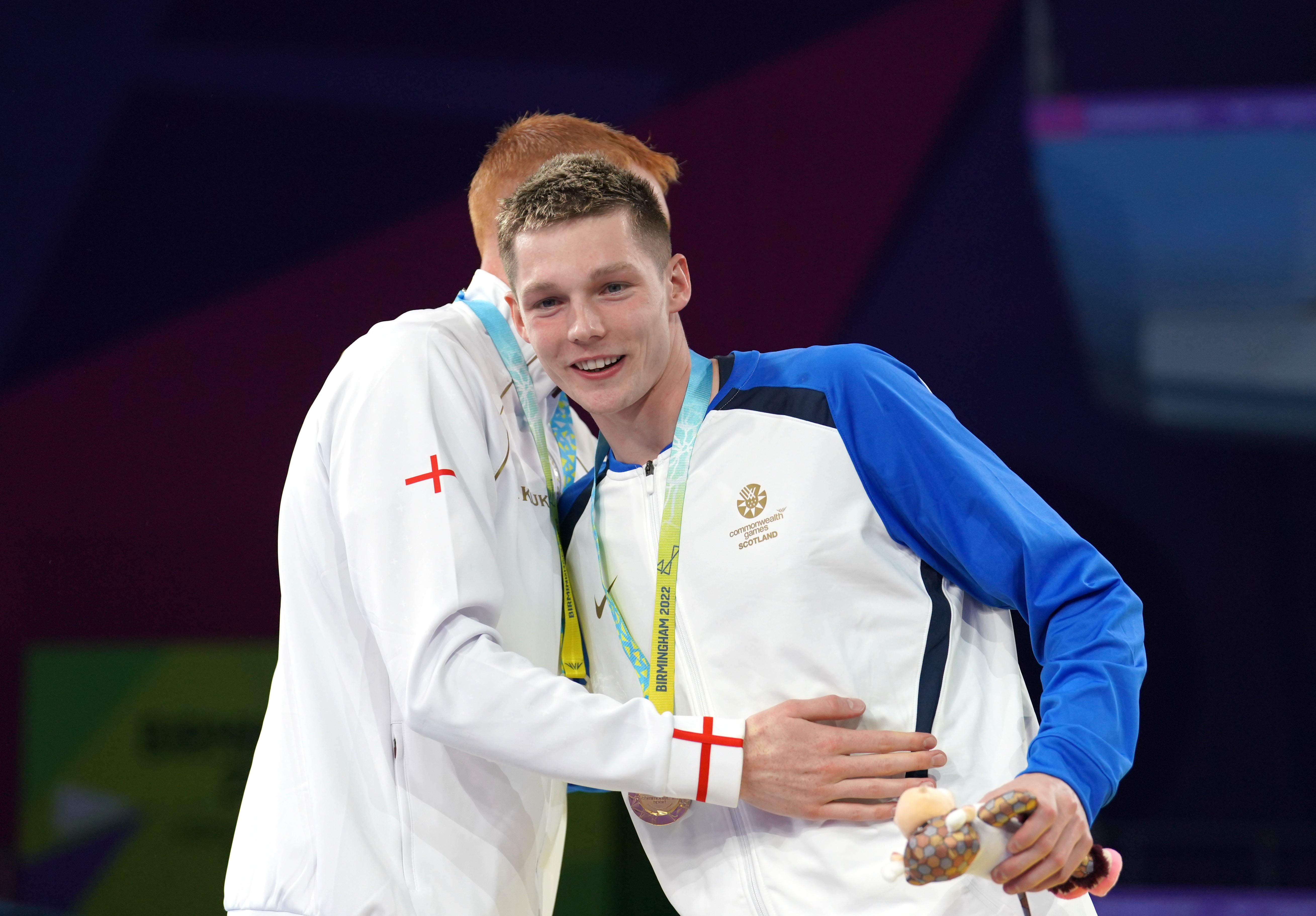 Dean and Scott hug on the podium after receiving their medals (David Davies/PA)