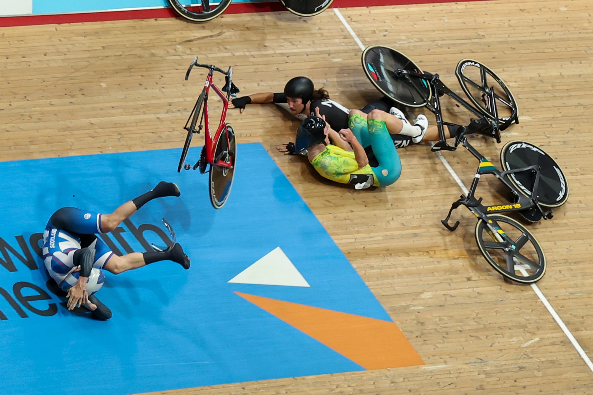 Riders crash on the final lap in the second heat of the men’s 15km scratch race qualifying event