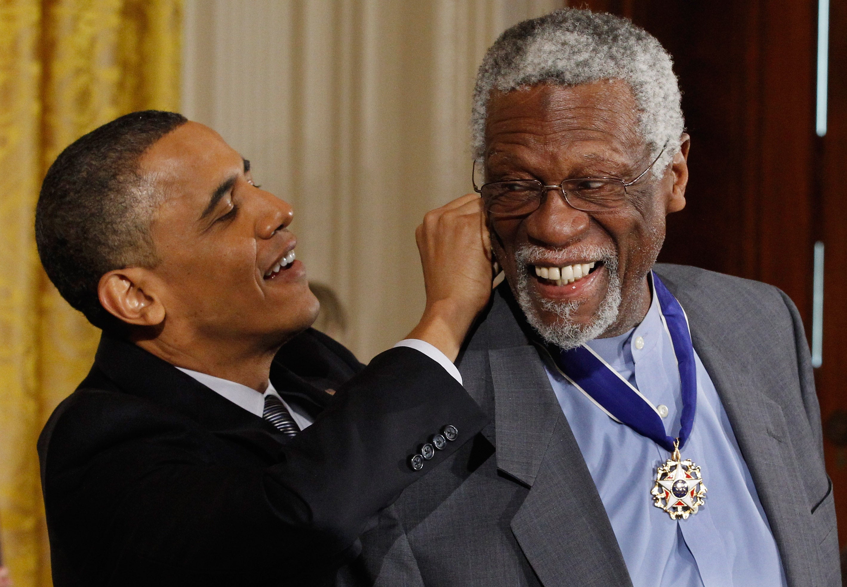 U.S. President Barack Obama (L) presents Basetball Hall of Fame member and human rights advocate Bill Russell the 2010 Medal of Freedom in the East Room of the White House February 15, 2011 in Washington, DC